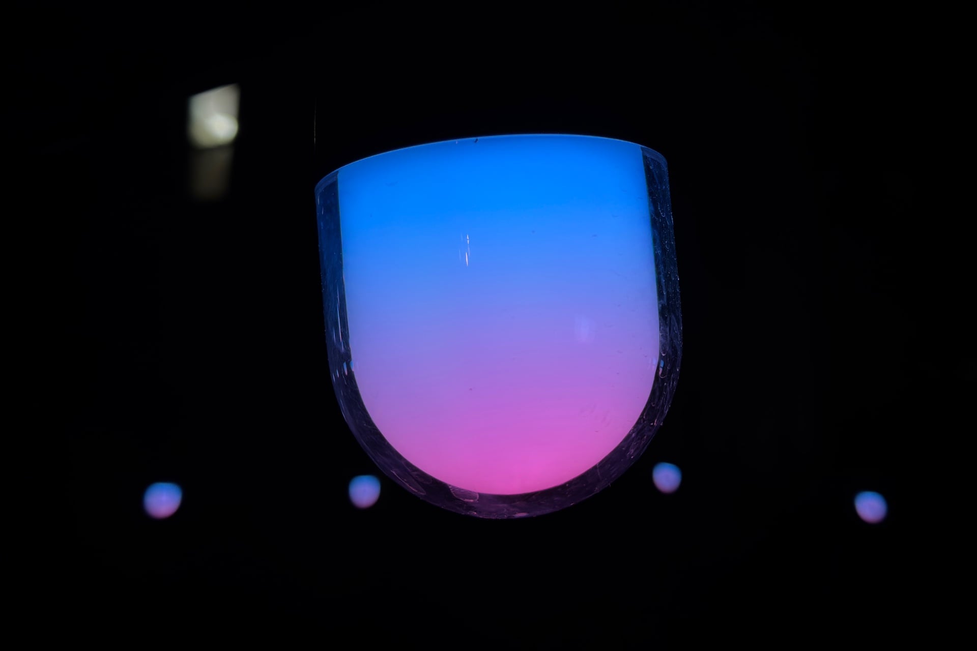 One of Govee's bulbs showing a blue-to-pink (from top to bottom) gradient at night.
