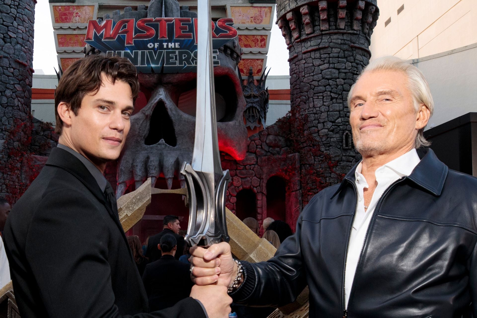 Nicholas Galitzine and Dolph Lundgren pose with the Sword of Power at the world premiere of Masters of the Universe in Hollywood, CA.