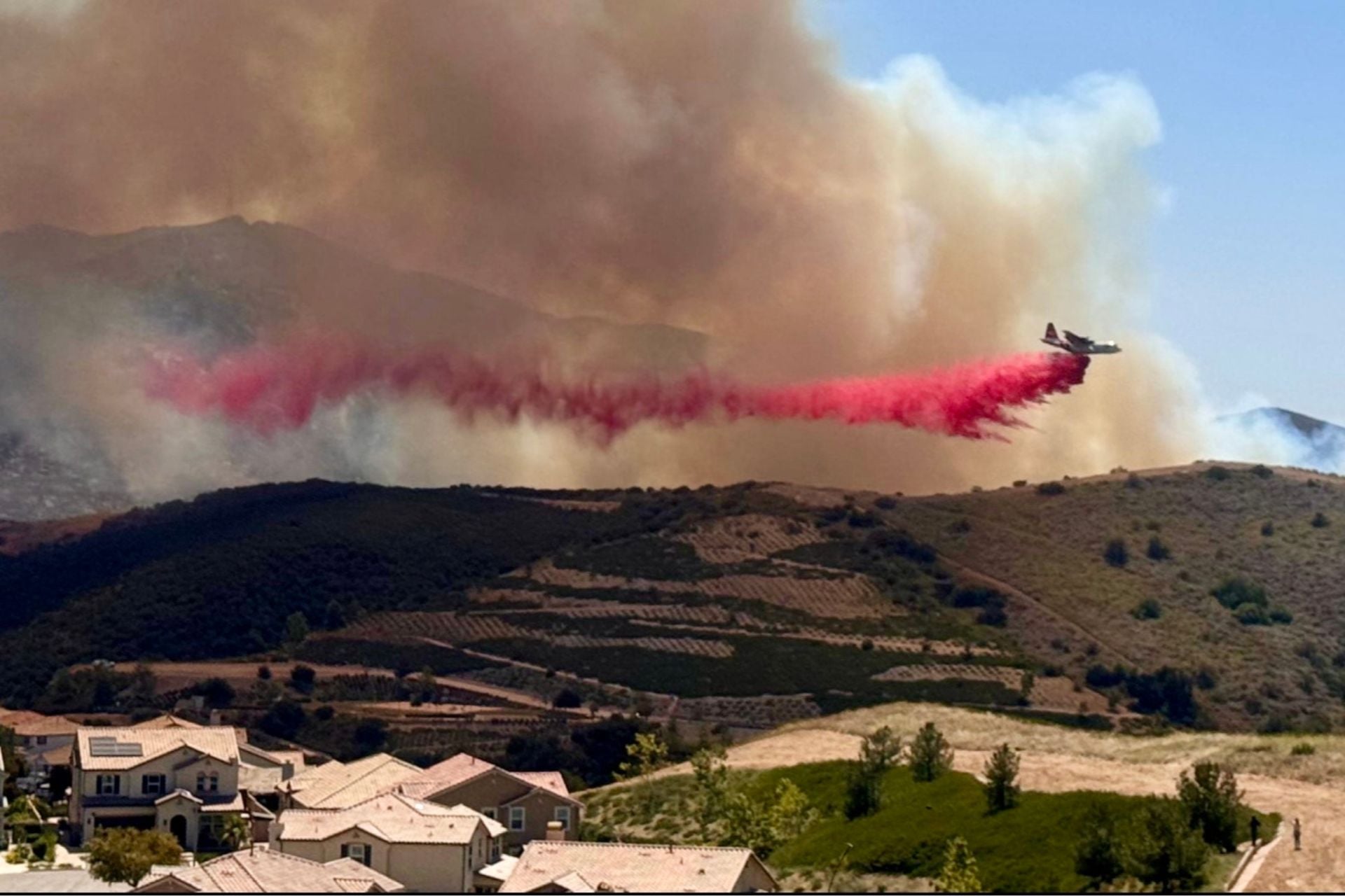 Firefighters drop retardant over the Sandy fire in Ventura County, California, on May 19, 2026. 