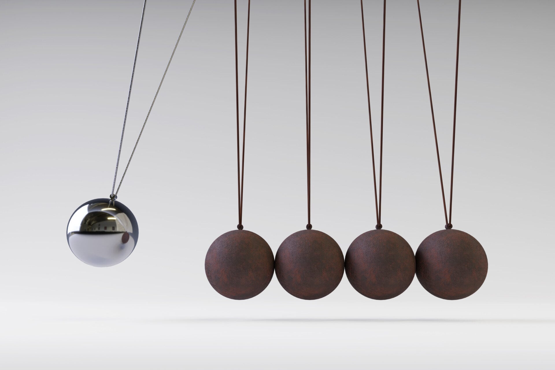 A 3D rendering of Newton's cradle, a device demonstrating the principles of conservation of momentum and conservation of energy in physics.