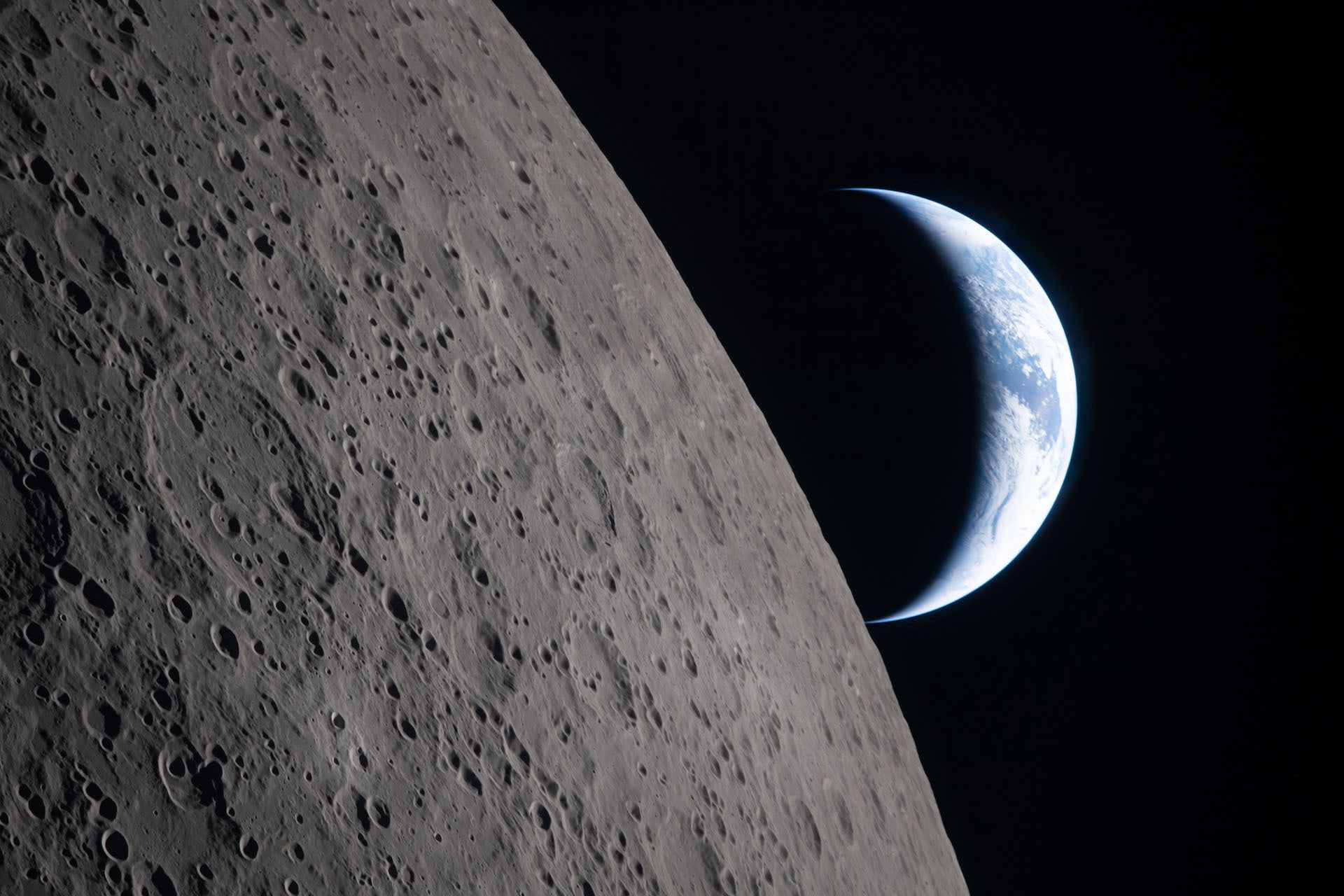 A stunning view of the Moon with Earth setting in the background. 