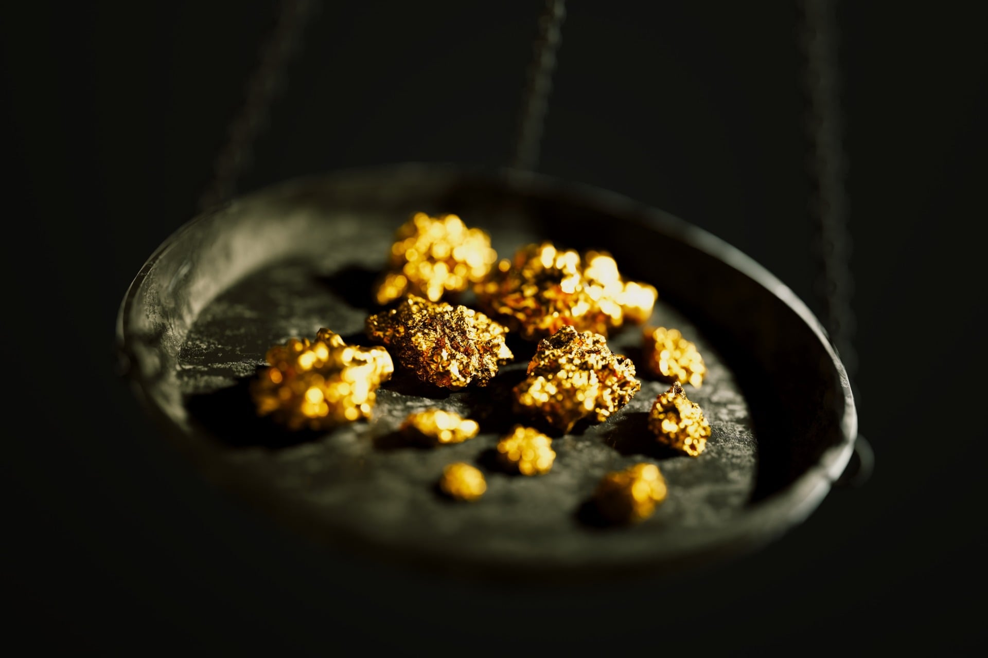 Close up of a jewelry scale with gold nuggets.