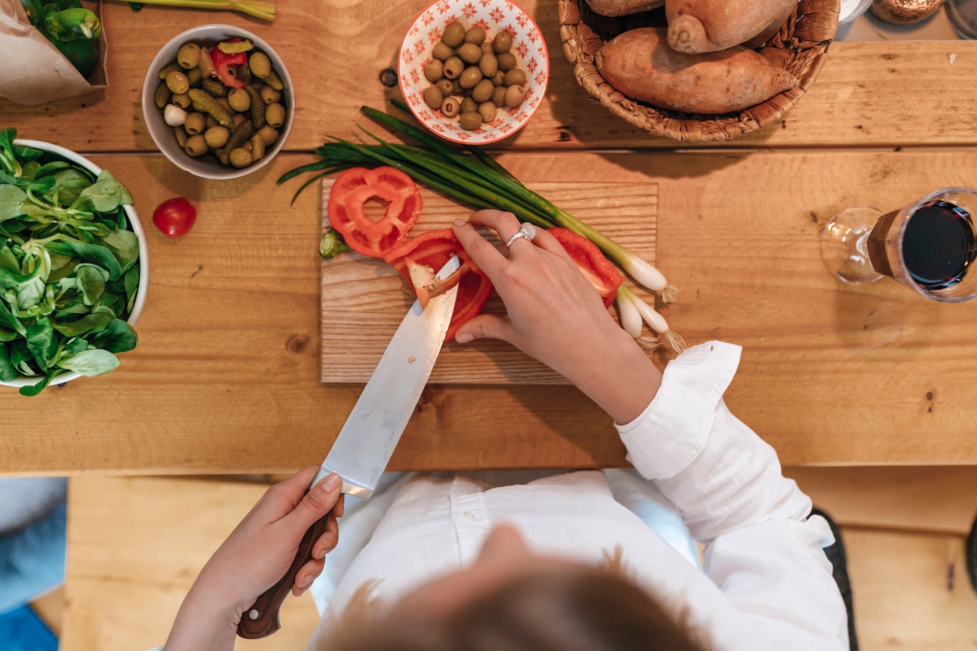 Woman Chopping Bell Pepper In The Kitchen, Top View