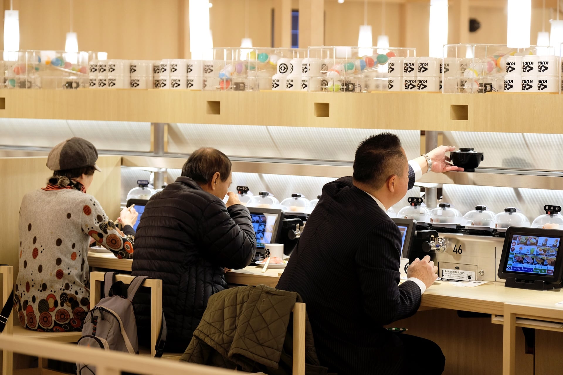 Customers dine at the global flagship store for Kura Sushi, a Japanese conveyor belt sushi restaurant chain, in the popular tourist area of Asakusa in Tokyo on January 22, 2020.  