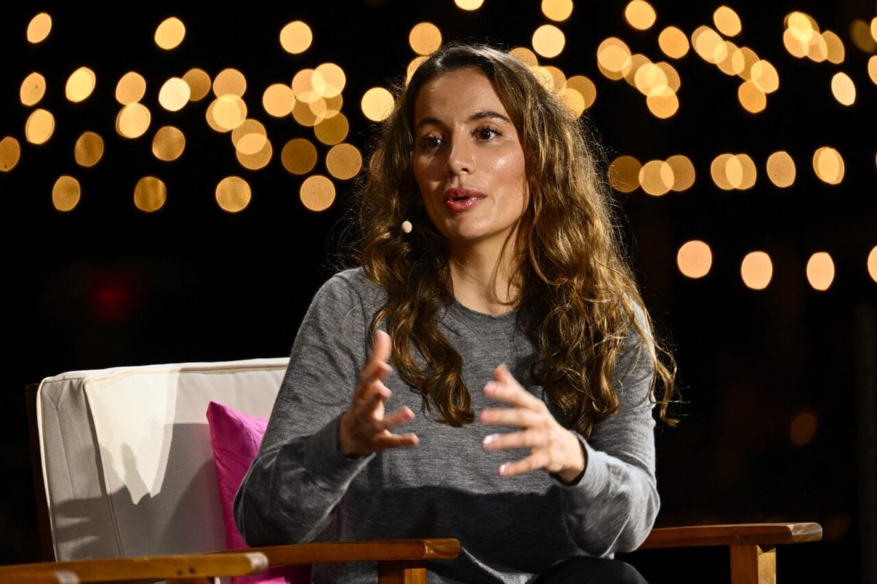 A woman speaking on a conference stage