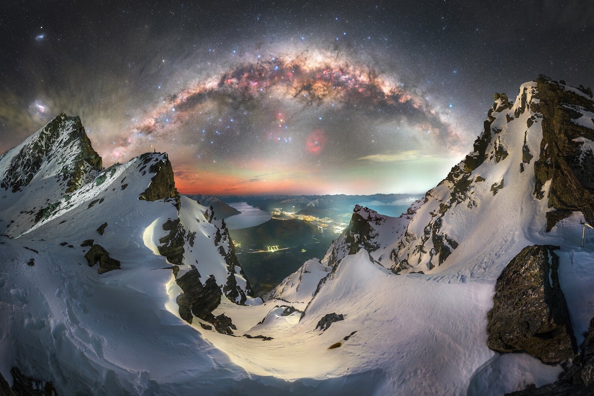 The arch of the Milky Way stretches above the Southern Alps in New Zealand. 