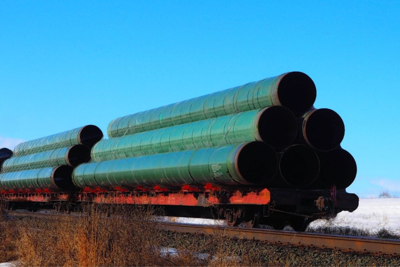 A railway flatcar loaded with large diameter pipe