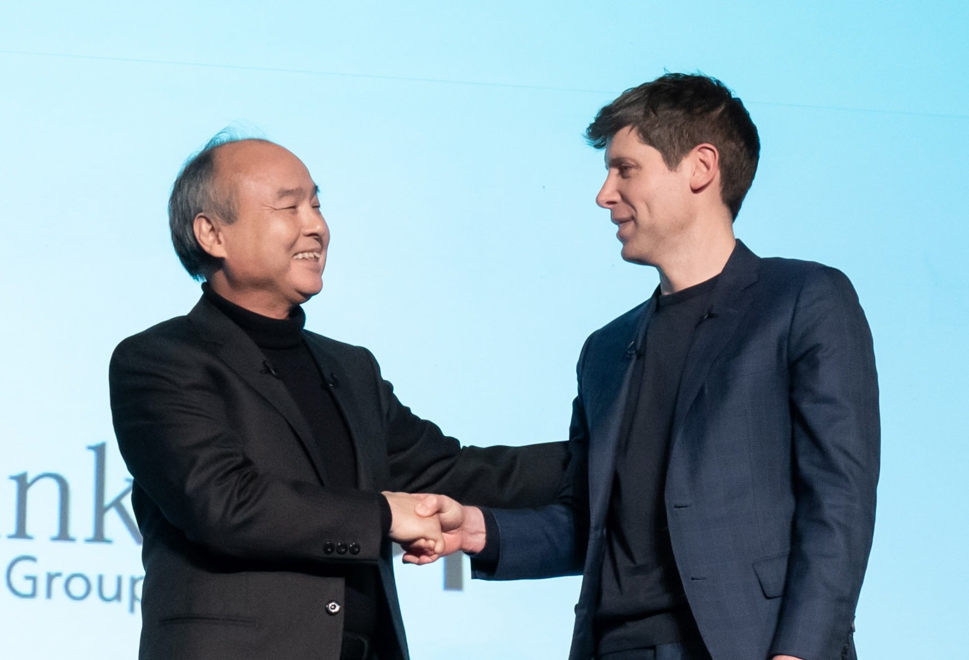 Masayoshi Son shaking hands with Sam Altman