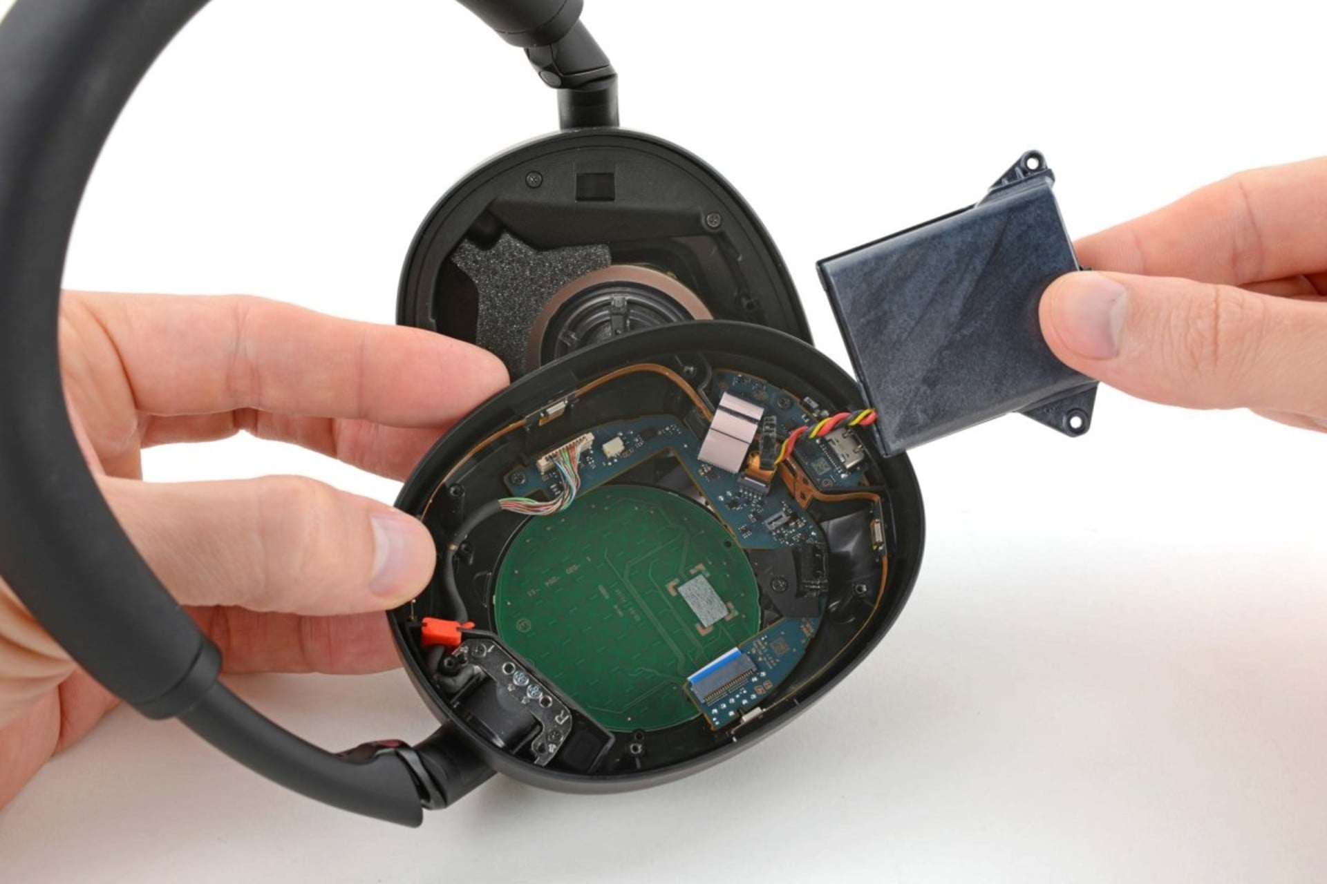A pair of Sony WH-1000XM6 pried open for testing.