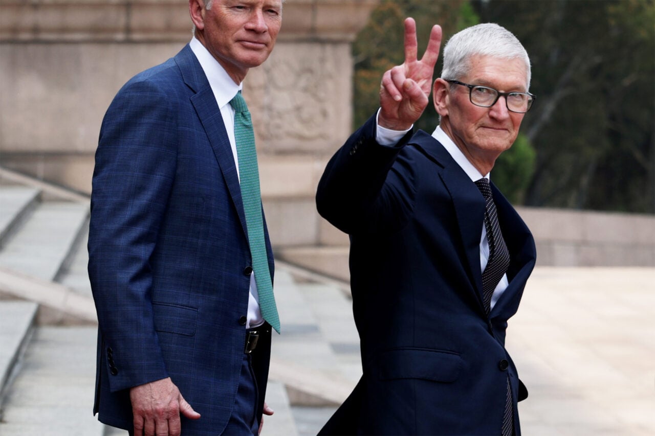 Tim Cook is seen giving a peace sign while on a trip to China.