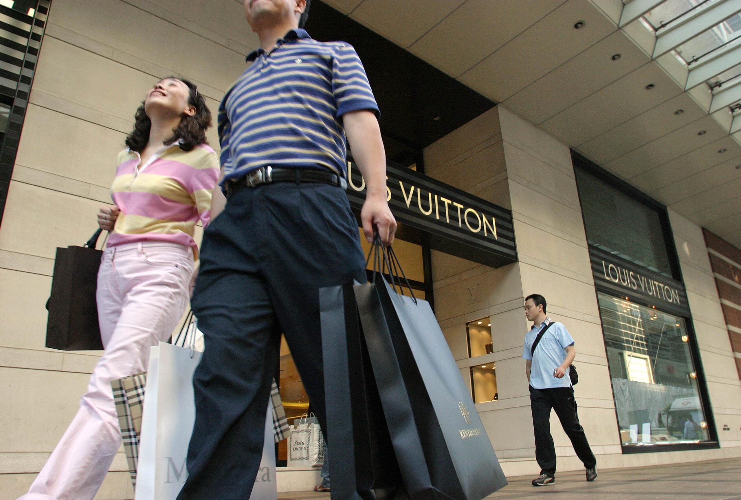 Shoppers in front of luxury stores