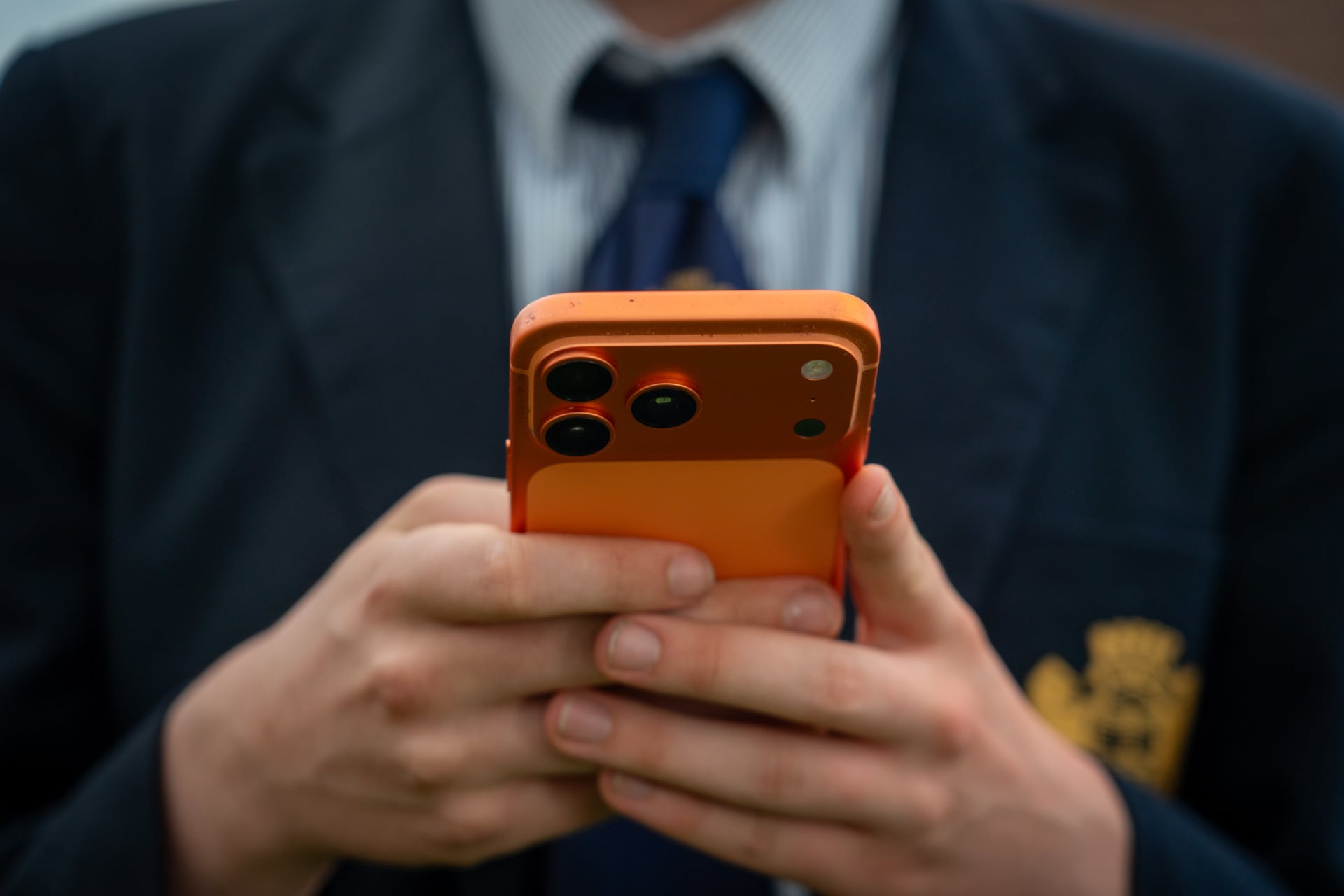 A teenager using an iPhone