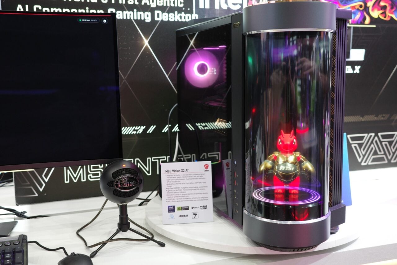 Msi Meg X2 Vision Desktop next to a monitor and a microphone