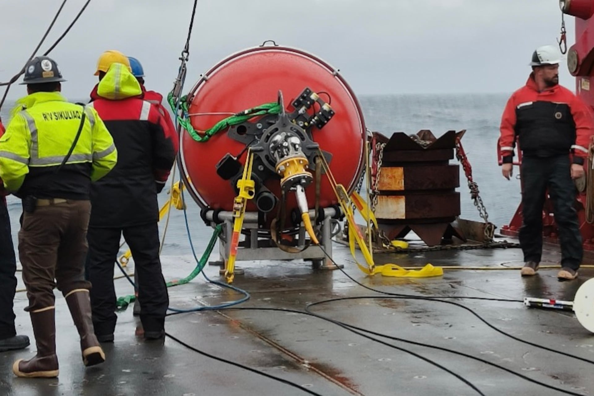 Crew on an Ocean Observatories Initiative expedition prepare to make a mooring deployment.