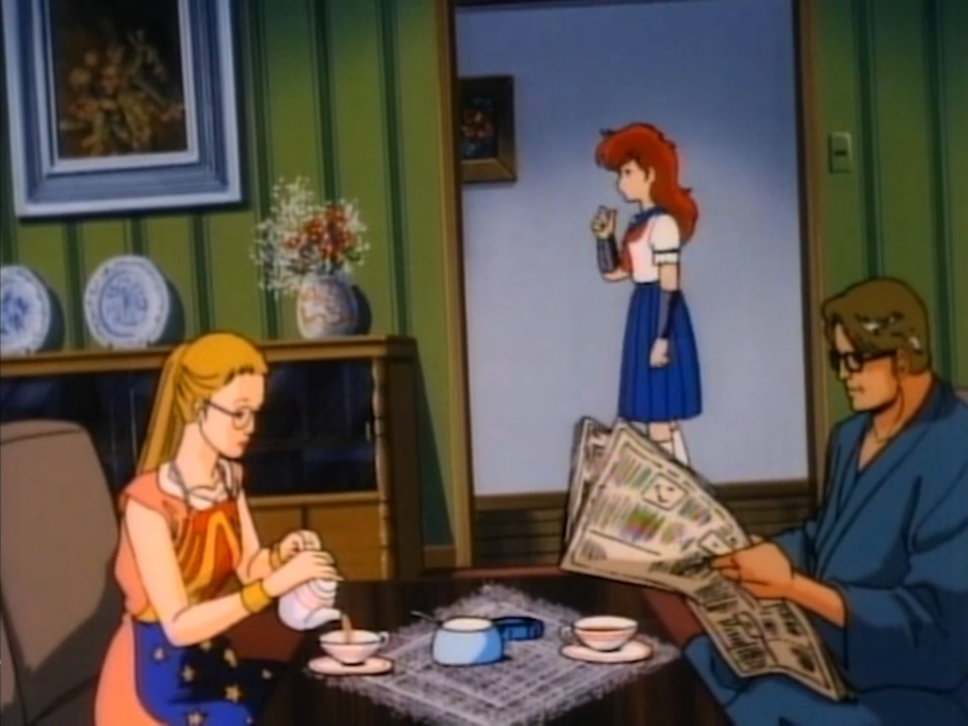 Project A-Ko still of Wonder Woman and Superman dining in the living room.