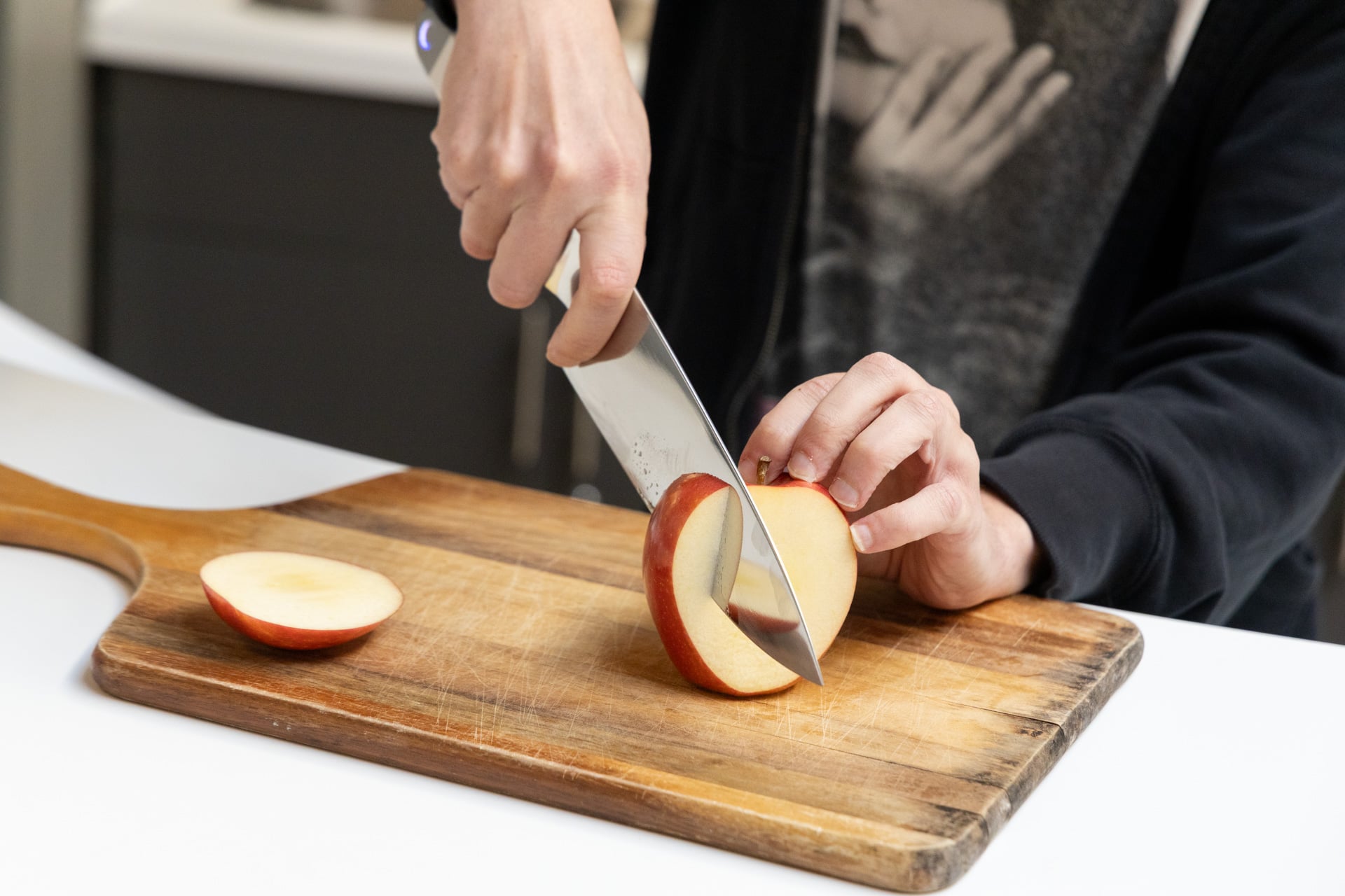 This Ultrasonic Knife Is More Than Just a Gimmick—at Least Sometimes
For someone who likes to cook, there is arguably no greater feeling than making a smooth-as-butter cut into a poor, innocent vegetable. I personally live for it, but as much as I love that feeling, it’s been increasingly tough to come by. My knives, I’m sad to say, are dull. Like, C-SPAN dull.
Two Shun knives—polished Japanese steel—have gradually fallen into a state of neglect-induced impotence under my watch, and I’m the only one to blame. I need to sharpen them—not a quick tango with the honing steel; we’re talking whetstone territory. The thing is, I’m hesitant to venture there. Not only will I almost certainly scratch the sh*t out of the beautifully crafted steel, but I’m also not certain I have the skill to sharpen them correctly in the first place. I could bring them to a professional, sure, but the only thing I love more than slicing vegetables is not doing the 40,000 chores I’ve been meaning to get done for years. Who’s got the time? Or the patience? That’s rhetorical—if you do, I don’t want to hear about it. So, what’s a knife-loving procrastinator like me to do? There’s only one solution: I must go ultrasonic. Seattle Ultrasonics C-200 The C-200 ultrasonic chef’s knife is more than just a gimmick, but will only be noticeable with certain cuts and food items. Can slice razor thin Takes less force to cut certain food items Nice steel, ultrasonic or not Ultrasonic feature isn’t noticeable on everything you cut A bit bulkier than your average knife Not a kitchen gadget most people really need Pricey at 0 Gotta go fast Obviously, I could get my knives sharpened, but this is Gizmodo, and where’s the fun in a whetstone when you can just swap your old-fashioned steel for something newfangled like Seattle Ultrasonics’ 9 C-200 ultrasonic 8-inch chef’s knife? This is a gadget, I’m happy to say, that’s as ridiculous as it sounds.
© Raymond Wong / Gizmodo It’s a knife made from Japanese AUS-10 stainless steel that incorporates a commercial manufacturing technology. It vibrates the blade of the knife 30,000 to 40,000 times per second, creating microscopic movements meant to assist your cuts. Seattle Ultraonics claims that this method of cutting (which only existed in factories prior to the C-200) can reduce the amount of force needed to slice by as much as 50%. Not only that, but the ultrasonic element is also designed to make a dull blade feel sharper, which is great for knife-sharpening procrastinators like myself. It sounds like one of those gimmicks that’s too good to be true, and at first, I would have agreed with that assessment… until I didn’t.
The C-200 does work, though maybe not in a noticeable way for everything all the time. In my experience, the innovation of at-home ultrasonic cutting is situational. You’re not going to notice it cutting everything all the time, but when you do notice it, it’s pretty sick. What’s for dinner? So, what should you cut with the C-200? Tomatoes. You should cut tomatoes. This is arguably one of the first things that I really noticed the effect of the C-200 on, mostly because of the nature of the fruit. Tomatoes, you see, have a membrane, and most people with dull knives have probably encountered what happens when you mix your sad, under-loved knife with a tomato membrane—things get a little dicey, though not in a fun way. Cuts become coarse, and you end up applying too much force to the tomato in order to compensate, which makes cutting more dangerous and a lot less precise. Not with the C-200, though. Seattle Ultrasonics says that, to test the knife’s performance against tomatoes, you can simply tilt the knife on the fruit, press the button on the knife, and watch as the blade sinks in. I tried this, and it works… sort of. You still have to apply some force to get the C-200 to sink in, but not much, and not nearly as much as you would with a regular knife. It’s also not just the newly sharpened blade playing tricks on me.
© Raymond Wong / Gizmodo I tested cutting a tomato in all sorts of ways, both with the ultrasonic feature activated and not, and there is a noticeable difference when you’re smashing that ultrasonic button. Not only does it make entry into the cut easier, but it makes slicing thin a lot smoother. I tried cutting crossways to see how thin I could get a tomato slice, and the ultrasonic cut was significantly thinner—you can make paper-thin slices if that’s your thing. It’ll be great for that dreamcatcher made of tomatoes you’ve been meaning to craft. Tomatoes aren’t the only place where the C-200 shines. I find the knife to be particularly efficient at cutting meat, both cooked and uncooked. Slicing raw chicken, for example, felt particularly smooth when I butterflied a breast using the feature. Carving a cured hunk of ham was also noticeably much easier with the button pressed than without. Cutting crusty bread (a baguette) also felt easier, requiring a bit less force, with ultrasonic power, which is nice considering you’re typically supposed to use a serrated knife for that.
Basically, if there’s a situation where a dull knife might get bogged down, the C-200 might perform better, and maybe even better than a sufficiently sharp regular blade. I say “might” and “maybe” in this case, because some things that Seattle Ultrasonics says are meant to be noticeable on the C-200 aren’t. © Raymond Wong / Gizmodo One thing I was excited to test out was cutting through thick, creamy stuff like cheese or butter. According to Seattle Ultrasonics, the C-200, since it vibrates while you slice, should slide through those food items more easily and with less food sticking to the blade. After slicing up quite a bit of cheese and some butter, though, I can’t say I noticed a huge difference. Maybe there was slightly less stickage, but not enough for me to declare the C-200 a revolution in butter cutting. As long as we’re talking about being underwhelmed, it’s worth noting that there are times (outside of butter and cheese) where you’re not going to notice much at all. Chopping onions as I normally do, for example, felt mostly the same with the ultrasonic button activated and not activated, and cutting fruits like apples and pears was almost indiscernible from regular slicing, as was slicing oyster mushrooms.
© Raymond Wong / Gizmodo I did smash some garlic with the flat side of the C-200 as well, and the knife didn’t feel like it was going to break or anything, which was nice, though I should hope a knife in this day and age is sturdy enough to smash garlic. Your satisfaction will depend largely on the health and quality of your current knives at home, too. If you’ve got a tip-top chef’s knife that you love to cut with (especially a Japanese one with a steeper angle than a “Western” knife), then the C-200 is going to have tougher competition. If you’re like me and are rocking less-than-ideal steel, then this blade may seem like a revelation. I’m really curious how the C-200 will fare over time, since Seattle Ultrasonics says that its tech can make a dull knife feel sharper, but wear and tear doesn’t happen that fast, so maybe I’ll save that question for a later date. One sec, I have to charge my knife There is no getting around the fact that the C-200 is a knife with a battery in it. I can’t say that I encountered any problems with that fact, but it obviously adds a new layer to knife ownership. One of those layers is that the handle is much thicker than most chefs’ knives of a similar size. I can’t say that it makes the C-200 feel unwieldy or anything, but I found that it makes it a little more clunky than a regular blade, and how much of that clunkiness you feel will depend on the size of your hand and your preferred knife feel. Speaking of knife feel, you cannot feel the vibrations of the blade while you’re holding it, which is good since having a knife wildly flail about when you’re cutting is a safety hazard.
© Raymond Wong / Gizmodo There’s a little bit of awkwardness with having to press a button while you slice things, but all things considered, Seattle Ultrasonics did put the button in an alright spot. I tried holding the knife in various ways, including by just gripping the handle like a caveman, but luckily it’s designed to be gripped as you would any other chef’s knife, which, for the uninitiated, is by choking up on the blade and punching it between your thumb and the knuckle/side of your index finger. If you’re not already holding your knife this way, you should. Thank me later. The C-200 obviously has a battery, too, which can be popped off from the end and charged via USB-C. I have to say, prying a battery off a handle with a very sharp blade attached to it isn’t the most comforting activity in the world since it does involve using some force, but I guess you get used to it. Just please exercise caution when you take the battery out if human fingers aren’t on tonight’s tasting menu. If you don’t want to pry the battery out, you can use a charging block sold by Seattle Ultrasonics that also wirelessly charges the knife, but that’s an extra 0. Most of the time, I’d rather risk losing a pinky than shell out an extra 0, though. The company does sell a bundle that costs 9, saving you . An extra battery also costs a pop if yours stops holding a charge or you want spares.
This charging block, sold separately, costs 0. © Raymond Wong / Gizmodo Battery life, by the way, is seemingly solid. Seattle Ultrasonics says you’ll get 20 minutes of continuous ultrasonic slicing and dicing, which is plenty if you’re just holding down the button for short durations while you slice something. I didn’t really encounter any battery life woes while using the knife over the course of the week, but it will depend on how much you cook and how long you’re cooking. I’m curious how the battery holds up long term and with continuous use, but that’s hard to say without using the C-200 for a longer period. Oh, and let’s talk about washing. While Seattle Ultrasonics says you can rinse the blade in water as you would any other knife, you cannot submerge it. If you do submerge it, it’ll be okay for a few seconds, but you’re supposed to promptly take the knife out of said liquid and dry the outside and inside of the battery compartment with a dry cloth. You should not put the C-200 in the dishwasher, nor should you do that for any knife you respect. You cannot use the C-200 on metal or glass cutting boards, but, like… why are you using those to begin with? They’re not good for your knives or your soul (God told me so).
A cut above? Let me be very clear: you do not need an ultrasonic knife. Sharp knives have been holding it down in kitchens at home and in Michelin-starred restaurants for quite some time, and I don’t think the C-200 is going to change that. © Raymond Wong / Gizmodo That being said, there is something nice about cramming ultrasonic technology into an at-home knife. Maybe you’re really intent on getting the thinnest possible slices; maybe you don’t want to prolong inevitable knife maintenance; maybe you have mobility issues and need a little assist from time to time. In those cases, I can see the C-200 being a useful knife to have.
For most people, though, regular knives will do. Most kitchen gadgets aren’t really made to be revolutionary, though. Do you really need a sous vide machine? An air fryer? A smart meat thermometer? Probably not, but you might want them all the same. And who am I to stop you from stepping into the microscopically vibrational future, even if that future only feels real for some things, some of the time? #Ultrasonic #Knife #GimmickatKitchen Gadgets,knife,Reviews This Ultrasonic Knife Is More Than Just a Gimmick—at Least Sometimes
For someone who likes to cook, there is arguably no greater feeling than making a smooth-as-butter cut into a poor, innocent vegetable. I personally live for it, but as much as I love that feeling, it’s been increasingly tough to come by. My knives, I’m sad to say, are dull. Like, C-SPAN dull.
Two Shun knives—polished Japanese steel—have gradually fallen into a state of neglect-induced impotence under my watch, and I’m the only one to blame. I need to sharpen them—not a quick tango with the honing steel; we’re talking whetstone territory. The thing is, I’m hesitant to venture there. Not only will I almost certainly scratch the sh*t out of the beautifully crafted steel, but I’m also not certain I have the skill to sharpen them correctly in the first place. I could bring them to a professional, sure, but the only thing I love more than slicing vegetables is not doing the 40,000 chores I’ve been meaning to get done for years. Who’s got the time? Or the patience? That’s rhetorical—if you do, I don’t want to hear about it. So, what’s a knife-loving procrastinator like me to do? There’s only one solution: I must go ultrasonic. Seattle Ultrasonics C-200 The C-200 ultrasonic chef’s knife is more than just a gimmick, but will only be noticeable with certain cuts and food items. Can slice razor thin Takes less force to cut certain food items Nice steel, ultrasonic or not Ultrasonic feature isn’t noticeable on everything you cut A bit bulkier than your average knife Not a kitchen gadget most people really need Pricey at 0 Gotta go fast Obviously, I could get my knives sharpened, but this is Gizmodo, and where’s the fun in a whetstone when you can just swap your old-fashioned steel for something newfangled like Seattle Ultrasonics’ 9 C-200 ultrasonic 8-inch chef’s knife? This is a gadget, I’m happy to say, that’s as ridiculous as it sounds.
© Raymond Wong / Gizmodo It’s a knife made from Japanese AUS-10 stainless steel that incorporates a commercial manufacturing technology. It vibrates the blade of the knife 30,000 to 40,000 times per second, creating microscopic movements meant to assist your cuts. Seattle Ultraonics claims that this method of cutting (which only existed in factories prior to the C-200) can reduce the amount of force needed to slice by as much as 50%. Not only that, but the ultrasonic element is also designed to make a dull blade feel sharper, which is great for knife-sharpening procrastinators like myself. It sounds like one of those gimmicks that’s too good to be true, and at first, I would have agreed with that assessment… until I didn’t.
The C-200 does work, though maybe not in a noticeable way for everything all the time. In my experience, the innovation of at-home ultrasonic cutting is situational. You’re not going to notice it cutting everything all the time, but when you do notice it, it’s pretty sick. What’s for dinner? So, what should you cut with the C-200? Tomatoes. You should cut tomatoes. This is arguably one of the first things that I really noticed the effect of the C-200 on, mostly because of the nature of the fruit. Tomatoes, you see, have a membrane, and most people with dull knives have probably encountered what happens when you mix your sad, under-loved knife with a tomato membrane—things get a little dicey, though not in a fun way. Cuts become coarse, and you end up applying too much force to the tomato in order to compensate, which makes cutting more dangerous and a lot less precise. Not with the C-200, though. Seattle Ultrasonics says that, to test the knife’s performance against tomatoes, you can simply tilt the knife on the fruit, press the button on the knife, and watch as the blade sinks in. I tried this, and it works… sort of. You still have to apply some force to get the C-200 to sink in, but not much, and not nearly as much as you would with a regular knife. It’s also not just the newly sharpened blade playing tricks on me.
© Raymond Wong / Gizmodo I tested cutting a tomato in all sorts of ways, both with the ultrasonic feature activated and not, and there is a noticeable difference when you’re smashing that ultrasonic button. Not only does it make entry into the cut easier, but it makes slicing thin a lot smoother. I tried cutting crossways to see how thin I could get a tomato slice, and the ultrasonic cut was significantly thinner—you can make paper-thin slices if that’s your thing. It’ll be great for that dreamcatcher made of tomatoes you’ve been meaning to craft. Tomatoes aren’t the only place where the C-200 shines. I find the knife to be particularly efficient at cutting meat, both cooked and uncooked. Slicing raw chicken, for example, felt particularly smooth when I butterflied a breast using the feature. Carving a cured hunk of ham was also noticeably much easier with the button pressed than without. Cutting crusty bread (a baguette) also felt easier, requiring a bit less force, with ultrasonic power, which is nice considering you’re typically supposed to use a serrated knife for that.
Basically, if there’s a situation where a dull knife might get bogged down, the C-200 might perform better, and maybe even better than a sufficiently sharp regular blade. I say “might” and “maybe” in this case, because some things that Seattle Ultrasonics says are meant to be noticeable on the C-200 aren’t. © Raymond Wong / Gizmodo One thing I was excited to test out was cutting through thick, creamy stuff like cheese or butter. According to Seattle Ultrasonics, the C-200, since it vibrates while you slice, should slide through those food items more easily and with less food sticking to the blade. After slicing up quite a bit of cheese and some butter, though, I can’t say I noticed a huge difference. Maybe there was slightly less stickage, but not enough for me to declare the C-200 a revolution in butter cutting. As long as we’re talking about being underwhelmed, it’s worth noting that there are times (outside of butter and cheese) where you’re not going to notice much at all. Chopping onions as I normally do, for example, felt mostly the same with the ultrasonic button activated and not activated, and cutting fruits like apples and pears was almost indiscernible from regular slicing, as was slicing oyster mushrooms.
© Raymond Wong / Gizmodo I did smash some garlic with the flat side of the C-200 as well, and the knife didn’t feel like it was going to break or anything, which was nice, though I should hope a knife in this day and age is sturdy enough to smash garlic. Your satisfaction will depend largely on the health and quality of your current knives at home, too. If you’ve got a tip-top chef’s knife that you love to cut with (especially a Japanese one with a steeper angle than a “Western” knife), then the C-200 is going to have tougher competition. If you’re like me and are rocking less-than-ideal steel, then this blade may seem like a revelation. I’m really curious how the C-200 will fare over time, since Seattle Ultrasonics says that its tech can make a dull knife feel sharper, but wear and tear doesn’t happen that fast, so maybe I’ll save that question for a later date. One sec, I have to charge my knife There is no getting around the fact that the C-200 is a knife with a battery in it. I can’t say that I encountered any problems with that fact, but it obviously adds a new layer to knife ownership. One of those layers is that the handle is much thicker than most chefs’ knives of a similar size. I can’t say that it makes the C-200 feel unwieldy or anything, but I found that it makes it a little more clunky than a regular blade, and how much of that clunkiness you feel will depend on the size of your hand and your preferred knife feel. Speaking of knife feel, you cannot feel the vibrations of the blade while you’re holding it, which is good since having a knife wildly flail about when you’re cutting is a safety hazard.
© Raymond Wong / Gizmodo There’s a little bit of awkwardness with having to press a button while you slice things, but all things considered, Seattle Ultrasonics did put the button in an alright spot. I tried holding the knife in various ways, including by just gripping the handle like a caveman, but luckily it’s designed to be gripped as you would any other chef’s knife, which, for the uninitiated, is by choking up on the blade and punching it between your thumb and the knuckle/side of your index finger. If you’re not already holding your knife this way, you should. Thank me later. The C-200 obviously has a battery, too, which can be popped off from the end and charged via USB-C. I have to say, prying a battery off a handle with a very sharp blade attached to it isn’t the most comforting activity in the world since it does involve using some force, but I guess you get used to it. Just please exercise caution when you take the battery out if human fingers aren’t on tonight’s tasting menu. If you don’t want to pry the battery out, you can use a charging block sold by Seattle Ultrasonics that also wirelessly charges the knife, but that’s an extra 0. Most of the time, I’d rather risk losing a pinky than shell out an extra 0, though. The company does sell a bundle that costs 9, saving you . An extra battery also costs a pop if yours stops holding a charge or you want spares.
This charging block, sold separately, costs 0. © Raymond Wong / Gizmodo Battery life, by the way, is seemingly solid. Seattle Ultrasonics says you’ll get 20 minutes of continuous ultrasonic slicing and dicing, which is plenty if you’re just holding down the button for short durations while you slice something. I didn’t really encounter any battery life woes while using the knife over the course of the week, but it will depend on how much you cook and how long you’re cooking. I’m curious how the battery holds up long term and with continuous use, but that’s hard to say without using the C-200 for a longer period. Oh, and let’s talk about washing. While Seattle Ultrasonics says you can rinse the blade in water as you would any other knife, you cannot submerge it. If you do submerge it, it’ll be okay for a few seconds, but you’re supposed to promptly take the knife out of said liquid and dry the outside and inside of the battery compartment with a dry cloth. You should not put the C-200 in the dishwasher, nor should you do that for any knife you respect. You cannot use the C-200 on metal or glass cutting boards, but, like… why are you using those to begin with? They’re not good for your knives or your soul (God told me so).
A cut above? Let me be very clear: you do not need an ultrasonic knife. Sharp knives have been holding it down in kitchens at home and in Michelin-starred restaurants for quite some time, and I don’t think the C-200 is going to change that. © Raymond Wong / Gizmodo That being said, there is something nice about cramming ultrasonic technology into an at-home knife. Maybe you’re really intent on getting the thinnest possible slices; maybe you don’t want to prolong inevitable knife maintenance; maybe you have mobility issues and need a little assist from time to time. In those cases, I can see the C-200 being a useful knife to have.
For most people, though, regular knives will do. Most kitchen gadgets aren’t really made to be revolutionary, though. Do you really need a sous vide machine? An air fryer? A smart meat thermometer? Probably not, but you might want them all the same. And who am I to stop you from stepping into the microscopically vibrational future, even if that future only feels real for some things, some of the time? #Ultrasonic #Knife #GimmickatKitchen Gadgets,knife,Reviews