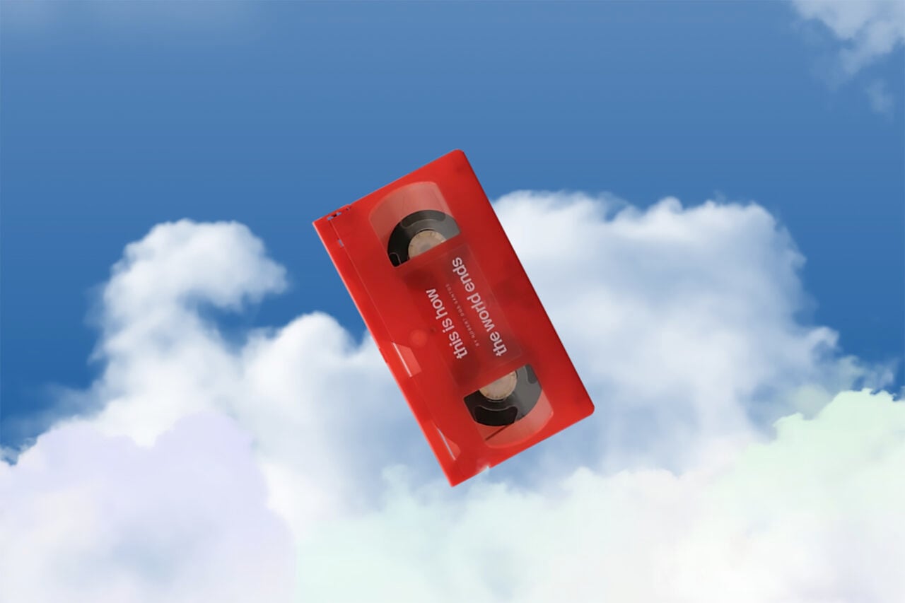 A copy of This Is How The World Ends on VHS is seen floating in the clouds.