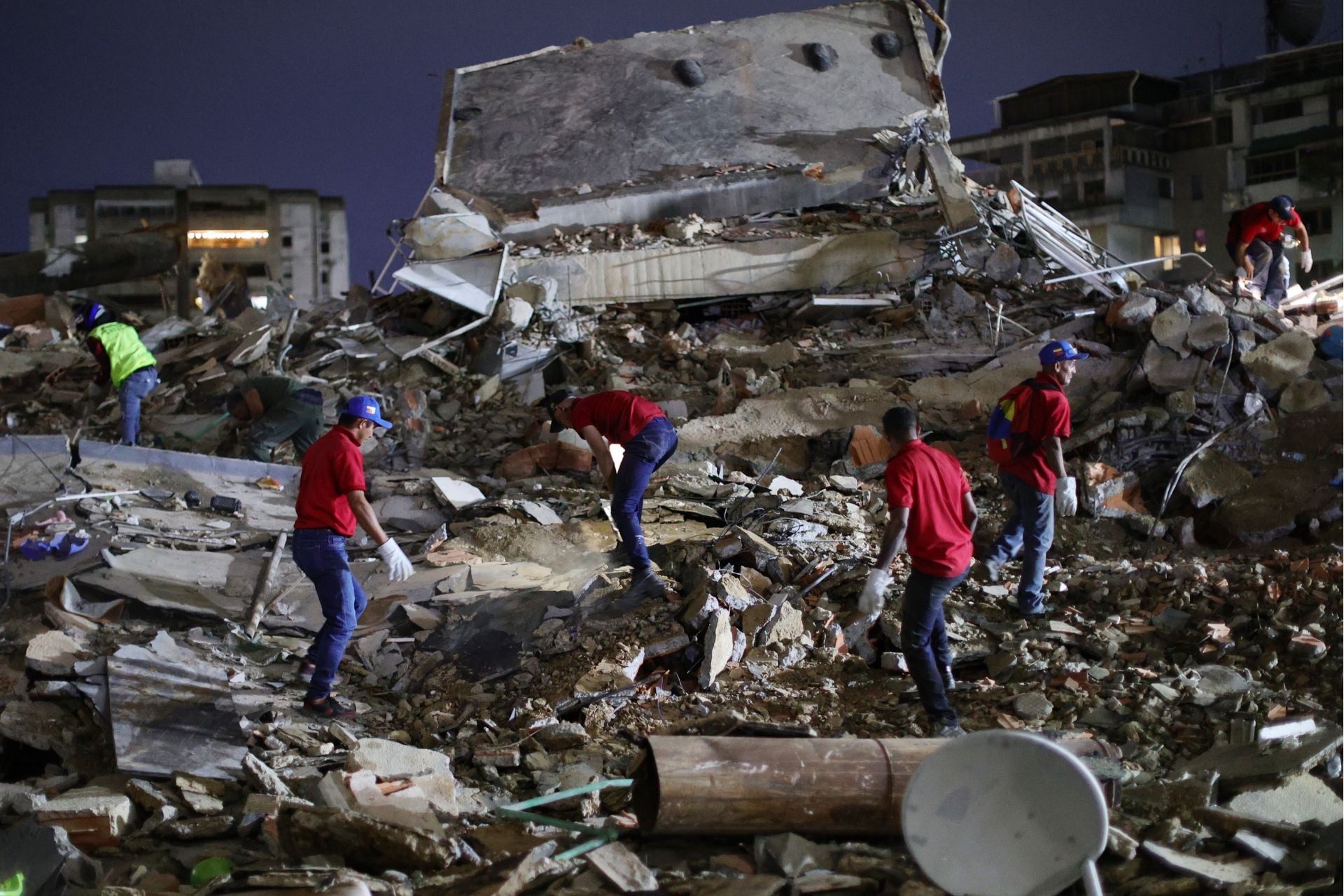 Responders search for victims amid building rubble in Caracas, Venezuela, after a magnitude 7.2 earthquake struck Venezuela and other regions in the Caribbean on June 24, 2026.