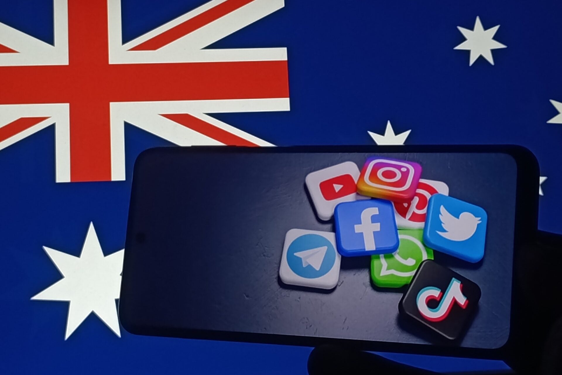 The Australian flag and logos of some of the platforms that the government banned for under 16s.