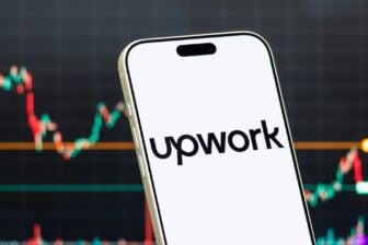 Upwork Inc. Logo Shown On Smartphone With Latest Stock Market Chart