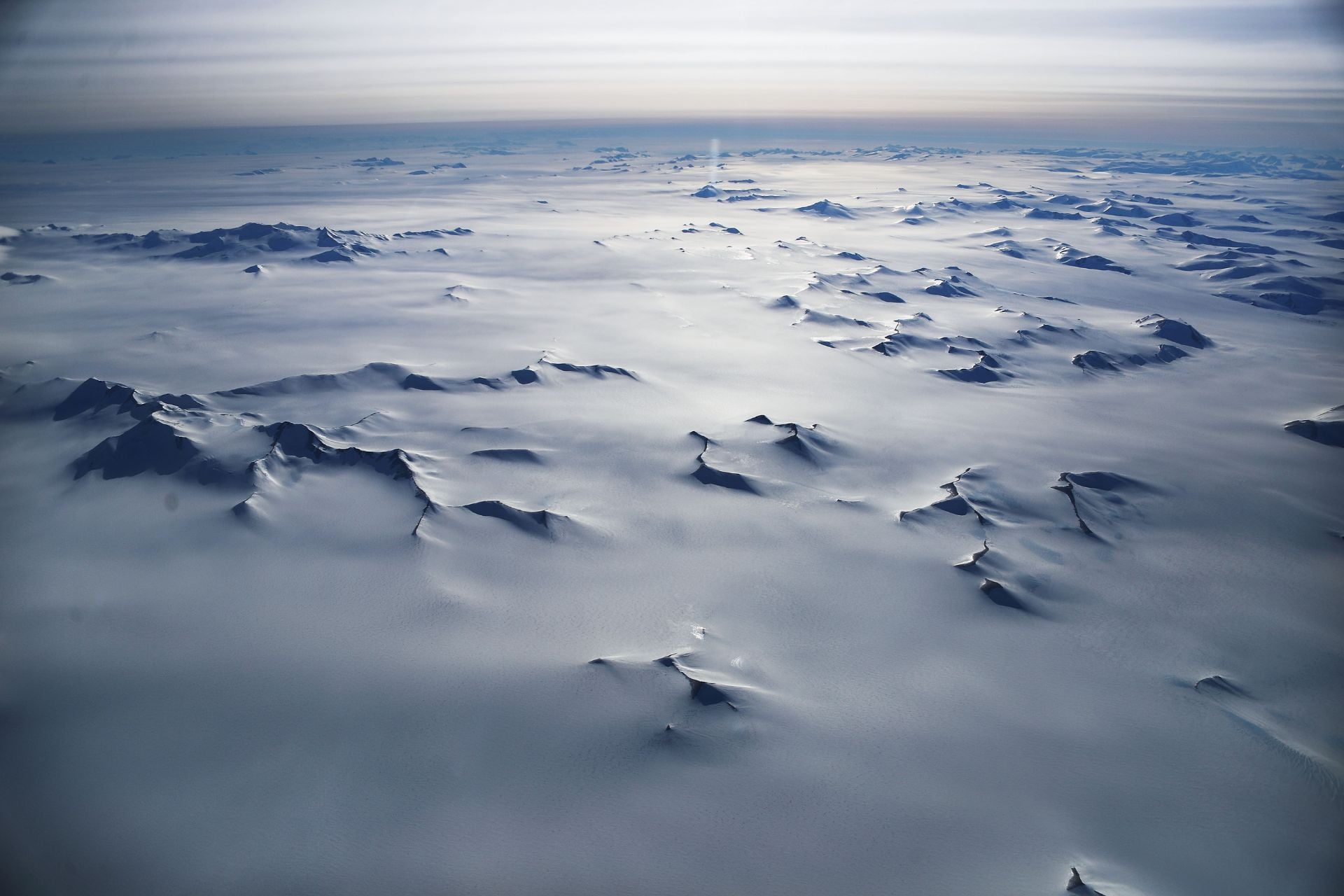 Mountain peaks are seen from NASA's Operation IceBridge research aircraft in the Antarctic Peninsula region on November 4, 2017.