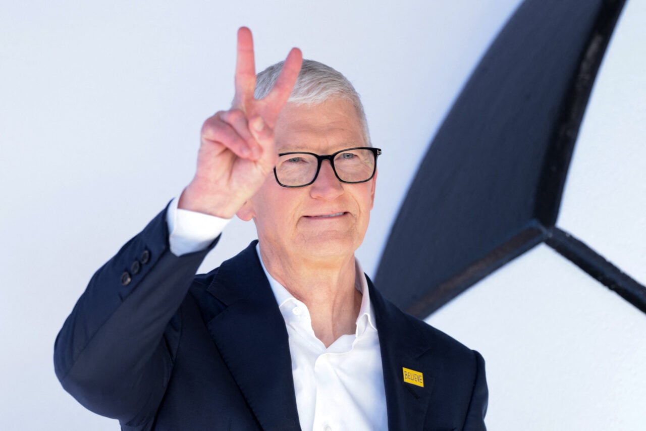 Apple CEO Tim Cook doing a peace sign