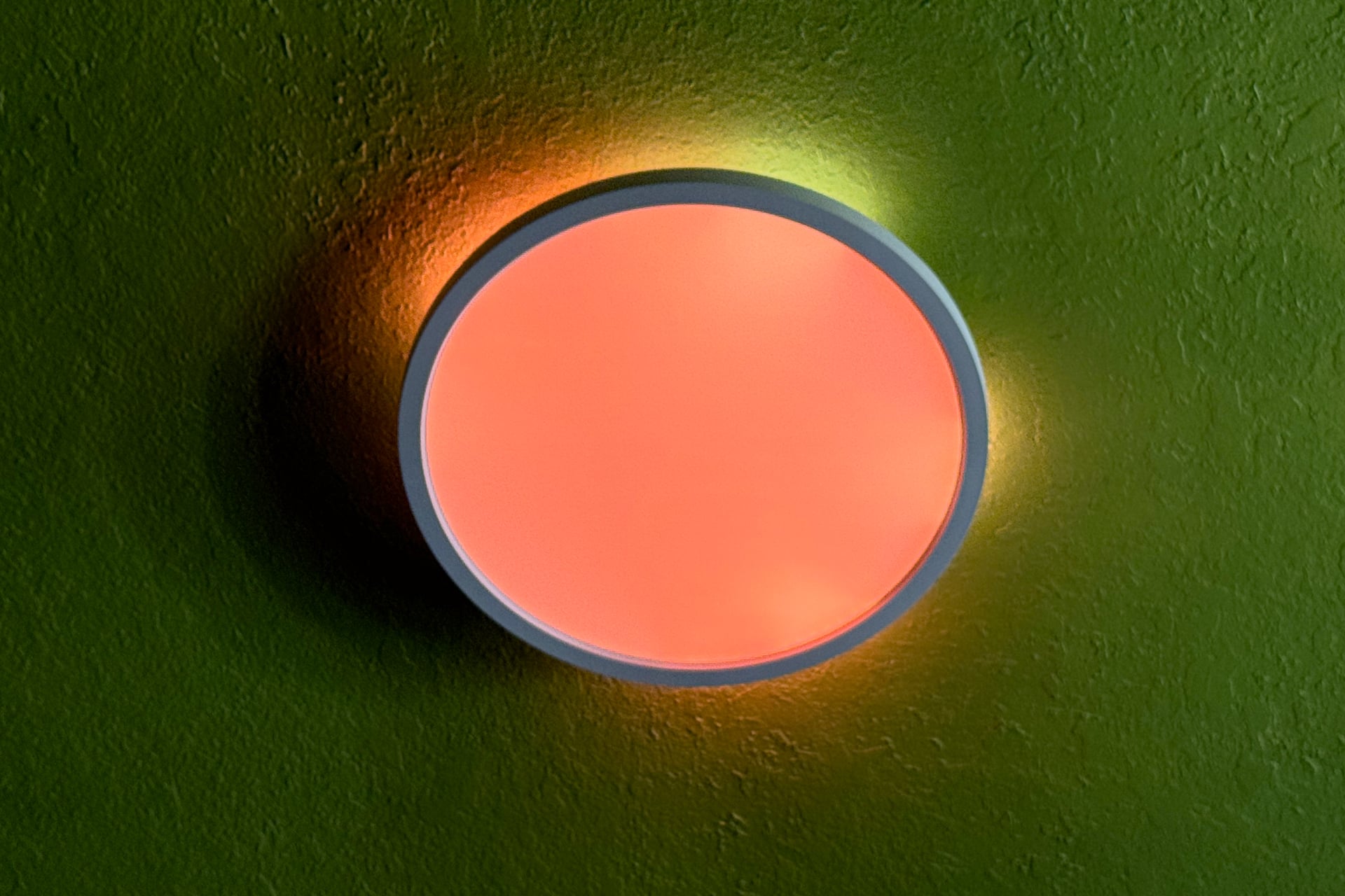 Nanoleaf Smart Multicolor ceiling light shhowing a peach and yellow effect