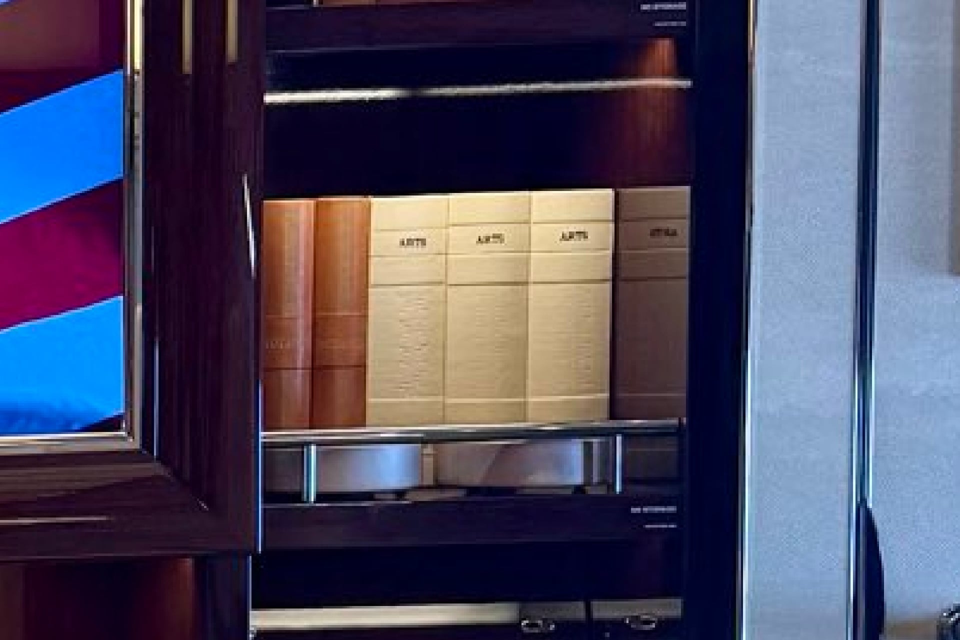 Close-up on a shelf on the new Air Force One, which features fake books with titles like "Library" and "Arts" and "Architecture."
