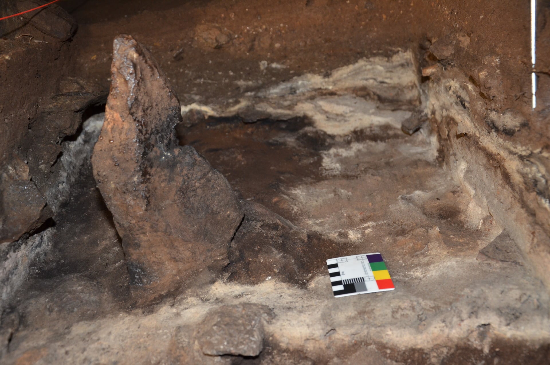 A 2,000 year-old standing stone, depicted during excavations. Burnt phytoliths came from the ashy layers surrounding the standing stone.
