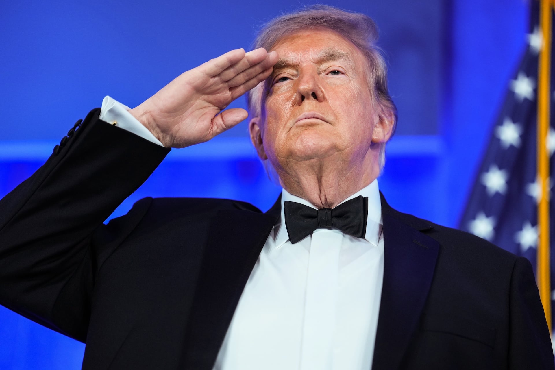U.S. President Donald Trump salutes during the National Anthem at the re-scheduled White House Correspondents Dinner in the Presidential Ballroom at the Waldorf Astoria on July 24, 2026 in Washington, DC. 