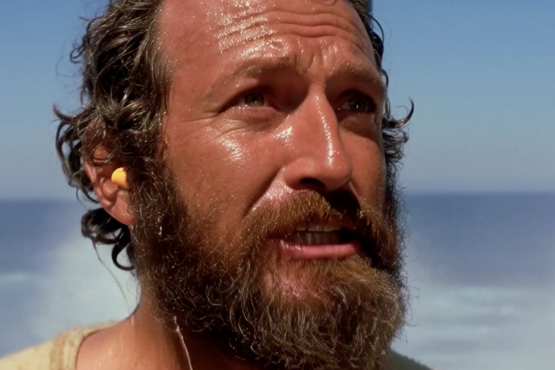 Screenshot from an AI movie clip created by Grok where the character of Odysseus has an orange foam earplug.