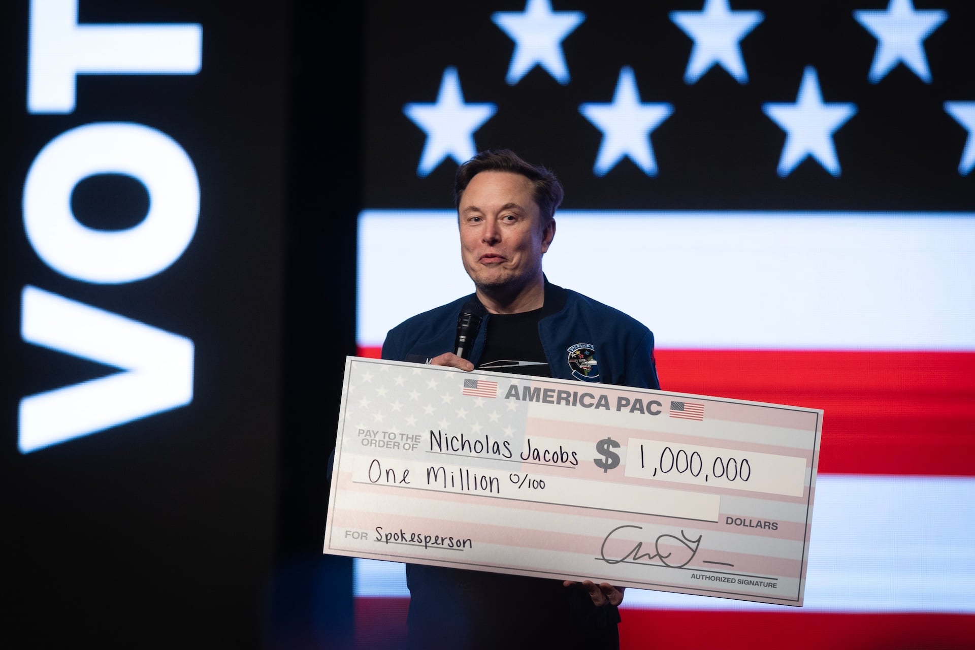 Elon Musk prepares to give $1,000,000 to a Wisconsin voter during a town hall meeting he was hosting at the KI Convention Center on March 30, 2025 in Green Bay, Wisconsin. 