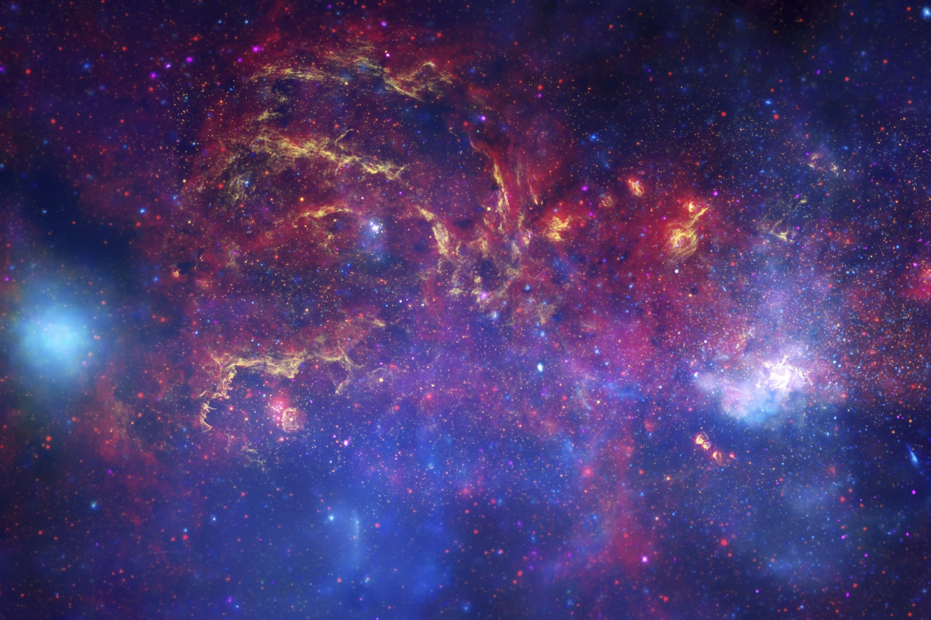 A composite image of the Milky Way's center (the Galactic Center) using observations from the Hubble Space Telescope, the Spitzer Space Telescope, and the Chandra X-ray Observatory.