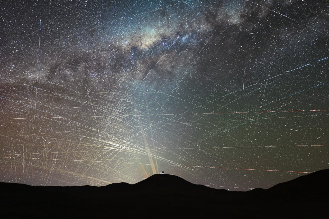This image shows satellites crossing the night sky above the northern Atacama Desert in Chile, over a period of just one hour. It is a stack of a time-lapse video taken on 15 October 2025 about two hours after sunset. A few streaks are caused by planes, and can be easily identified by their blinking-coloured lights, but most trails are due to satellites.