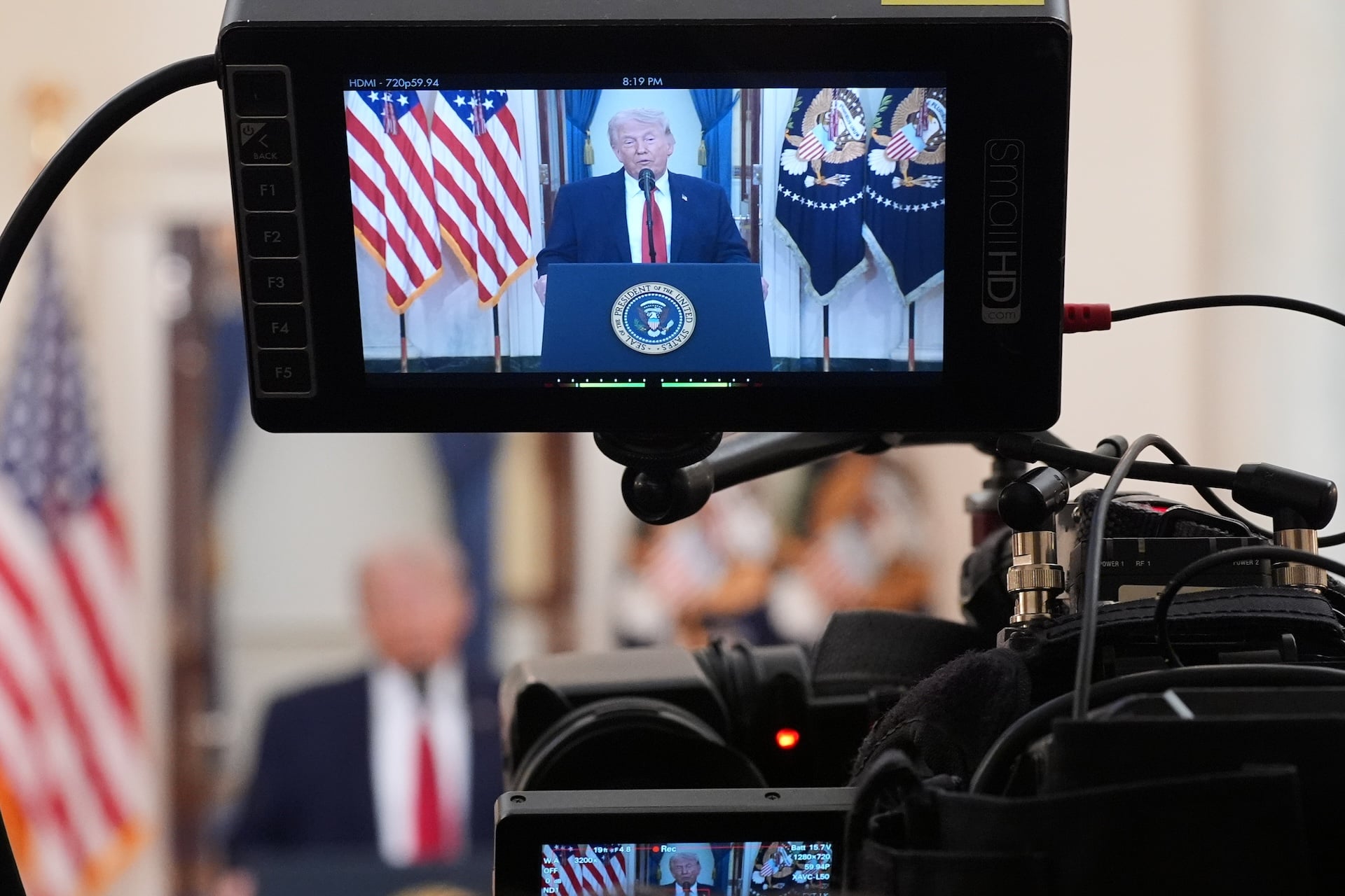President Donald Trump is shown on television monitor speaking from the Cross Hall of the White House on April 1, 2026 in Washington, DC.  