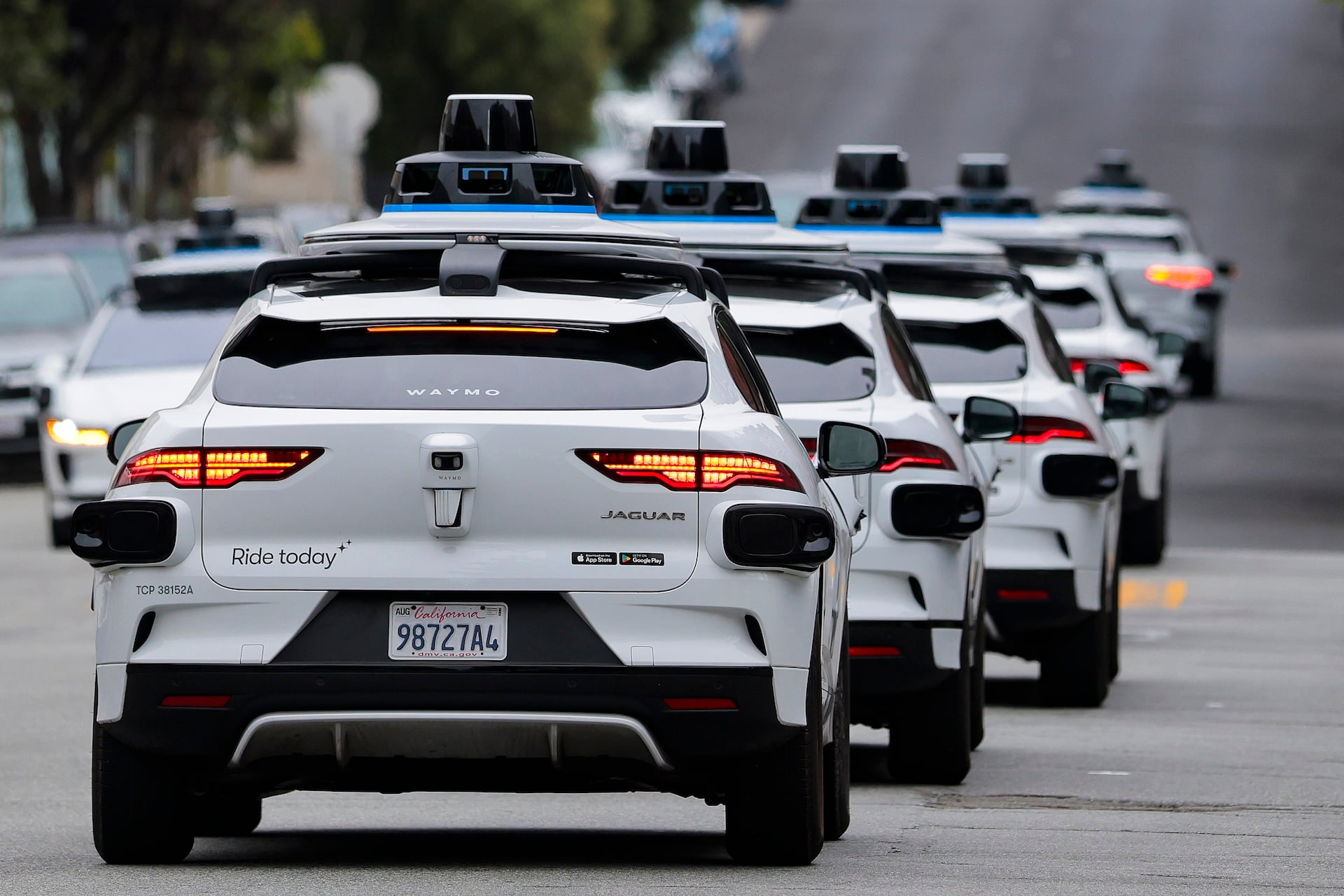 A line of Waymo robotaxis drives through North Beach on July 07, 2026 in San Francisco, California.  