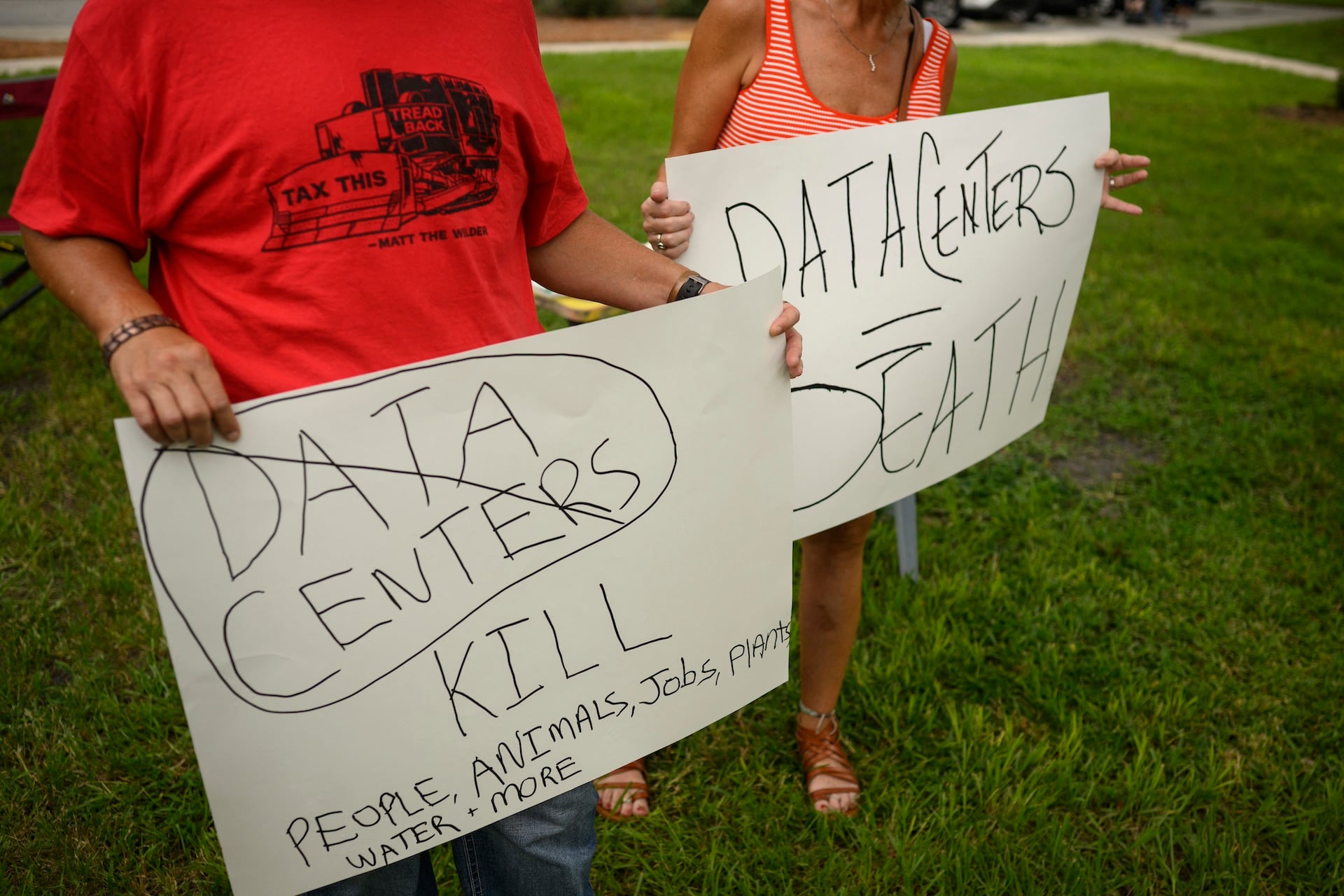 Protestors hold signs outside Peace Hall in New Port Richey, Florida on July 18, 2026.