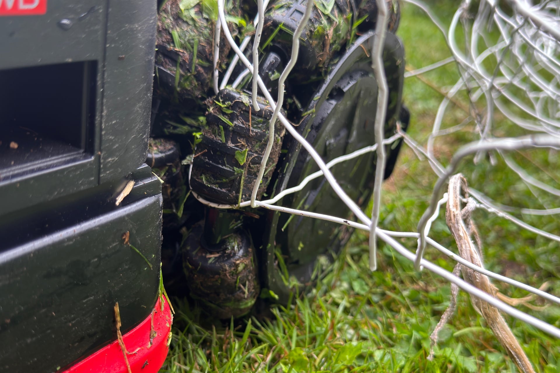 One of the Dreame A3 Awd Pro 3500's omnidirectional wheels badly snagged on a wire fence.