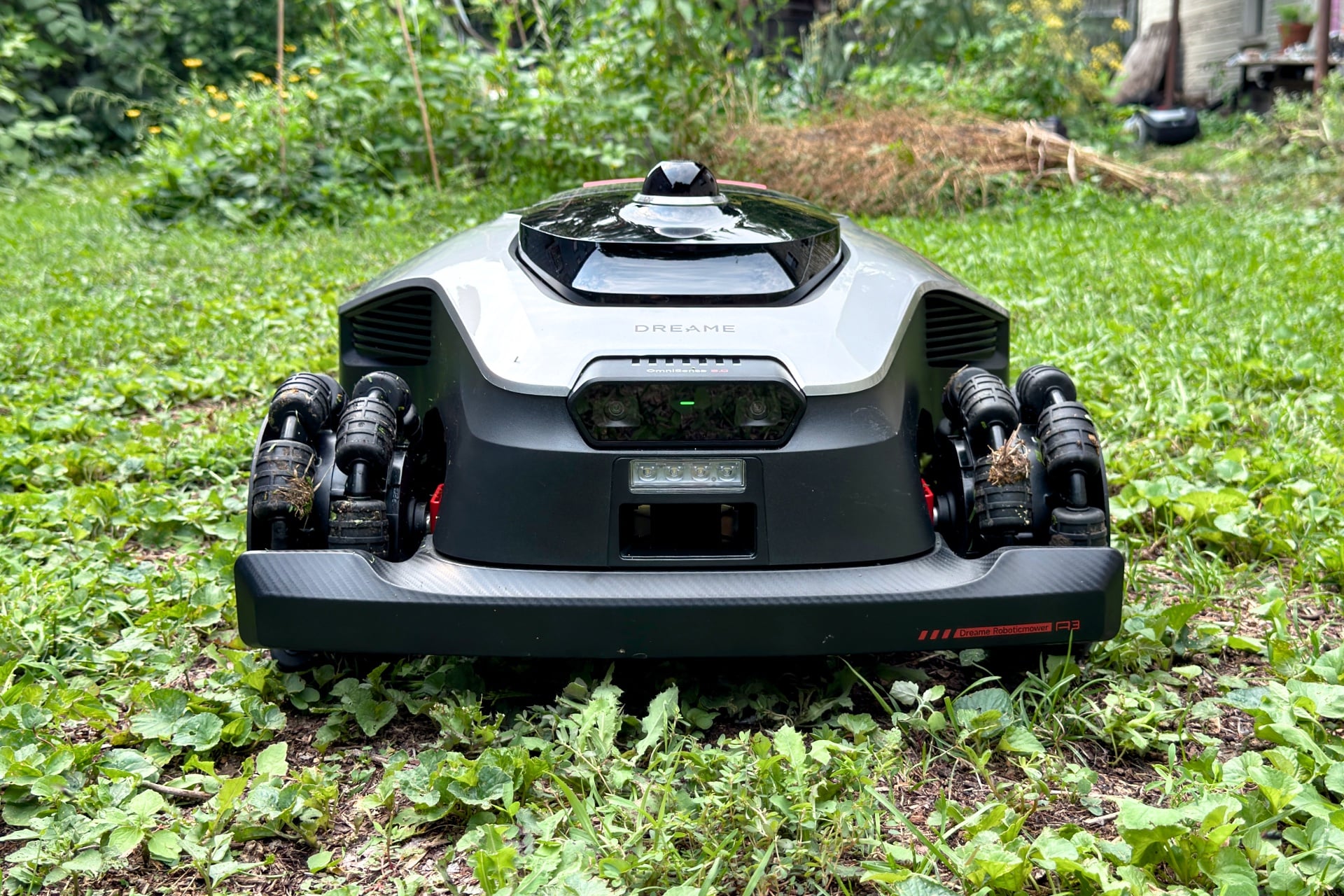 Front of the Dreame A3 Awd Pro 3500, showing its omnidirectional wheels, front bumper, and cameras