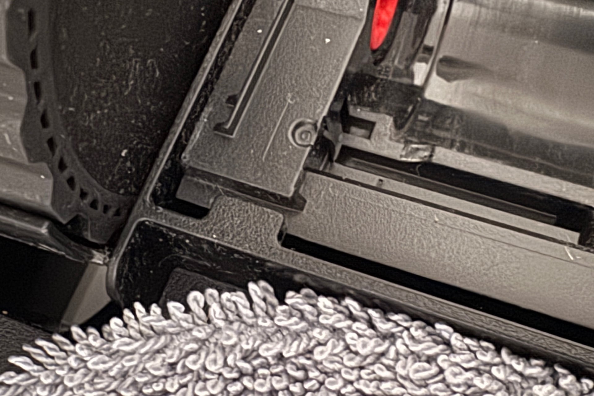 Picture of one of the two tabs on the bottom, holding the dust roller compartment down.