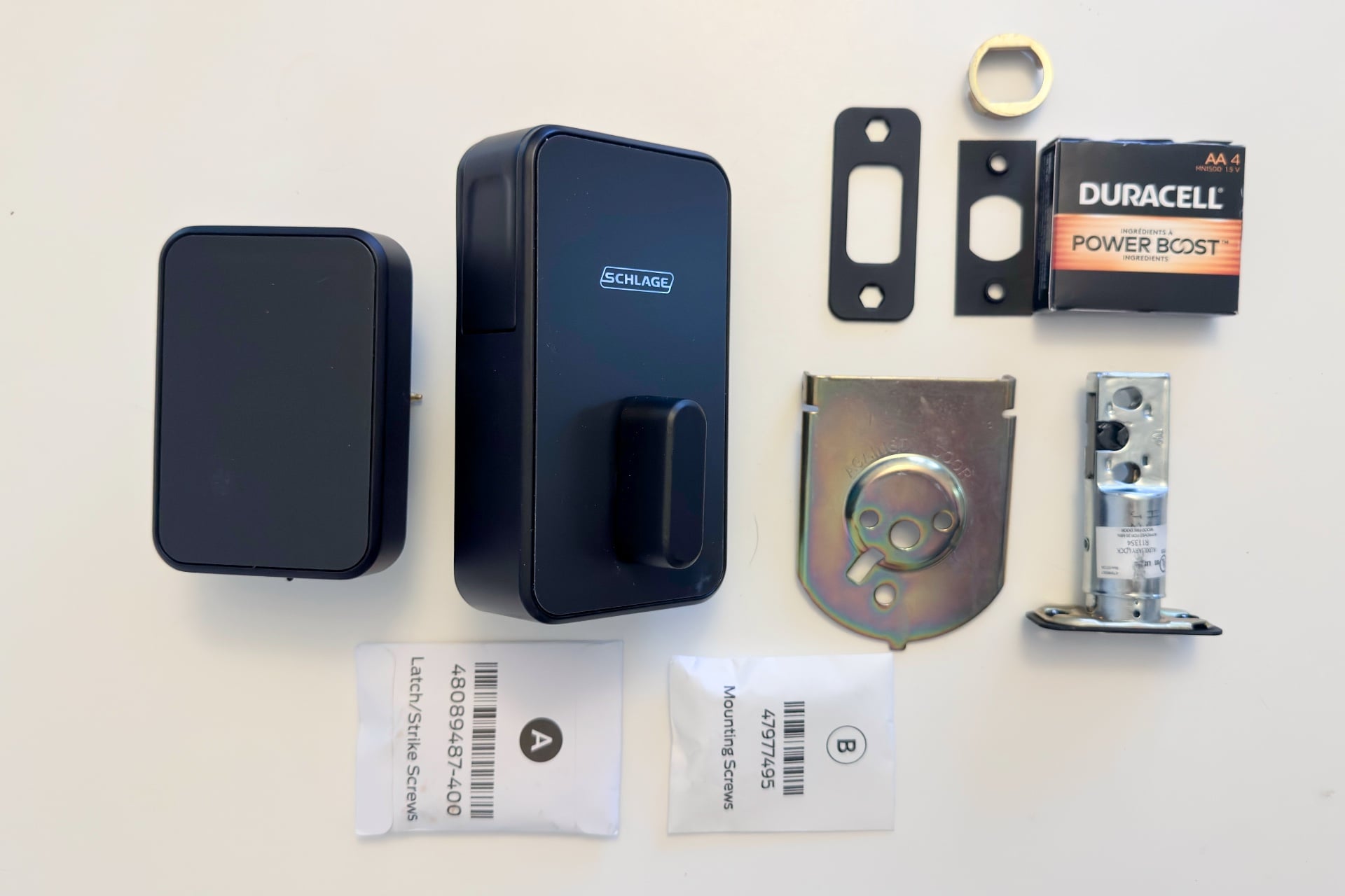 Schlage Sense Pro's parts laid out on a table.
