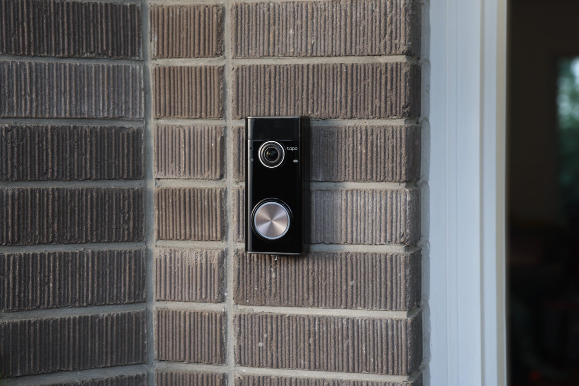 Image sowing the Tapo Doorbell Pro D260 installed on a brick wall.