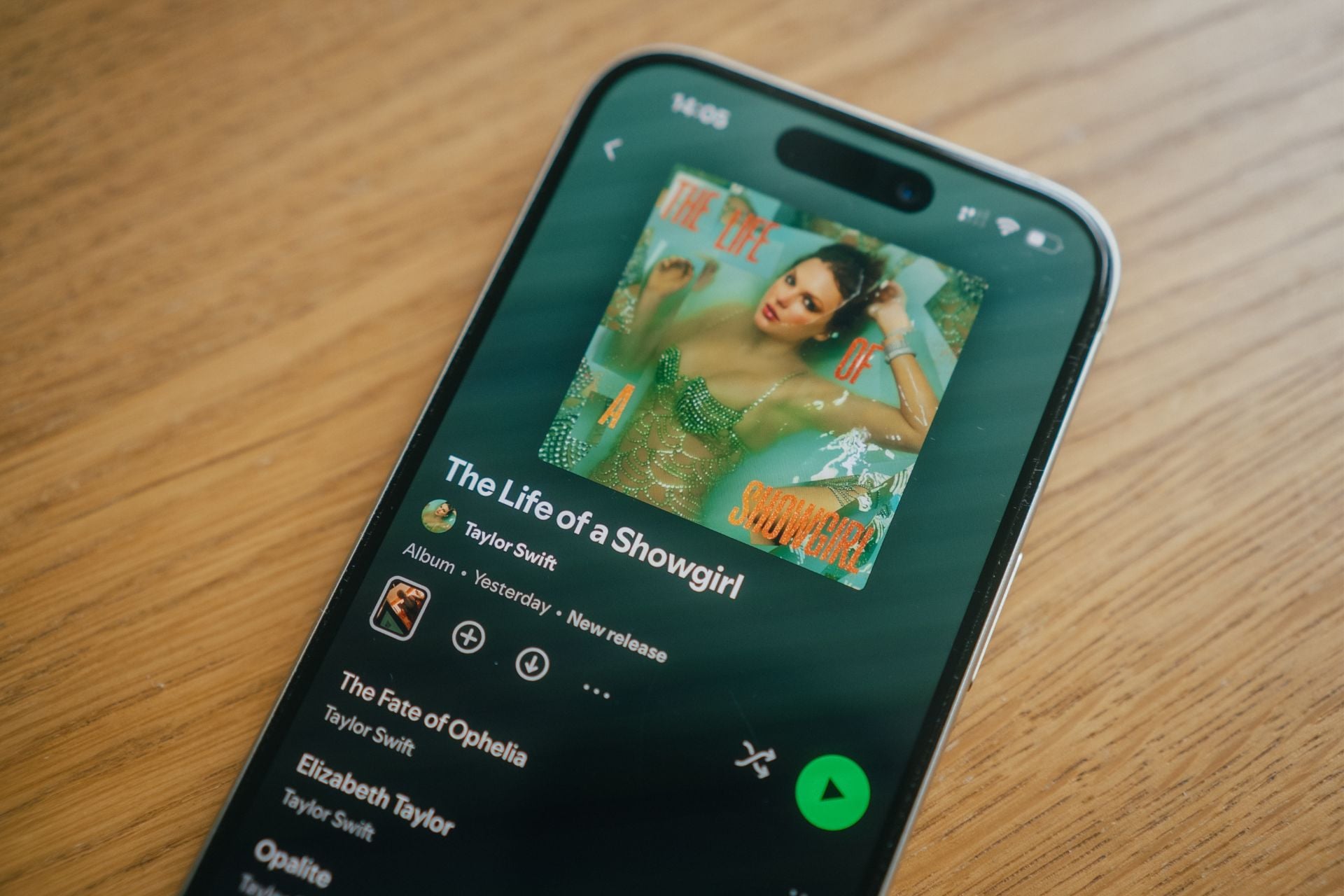 A phone with Spotify showing Taylor Swift’s latest hit album “The Life of a Showgirl.”