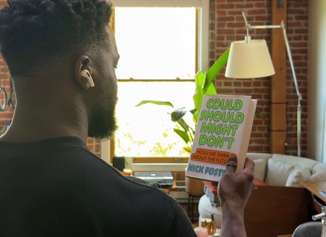 A guy with AirPods looking at a book