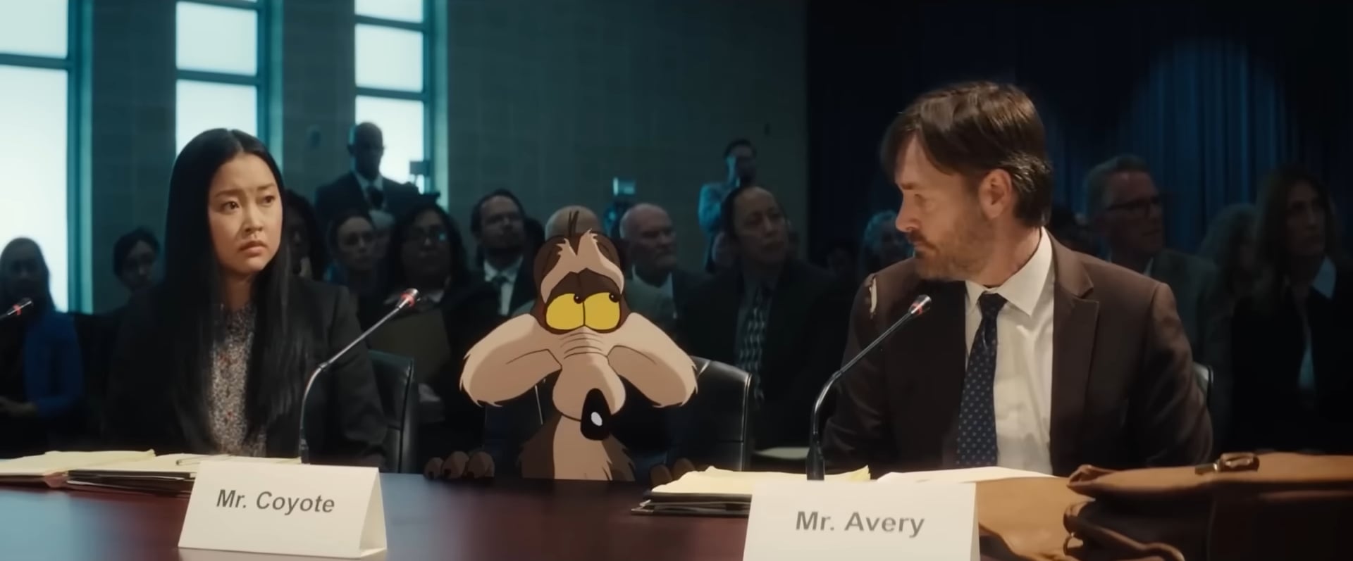 Coyote Vs Acme still of Will Forte and Lana Condor in a court room with Wile E. Coyote.