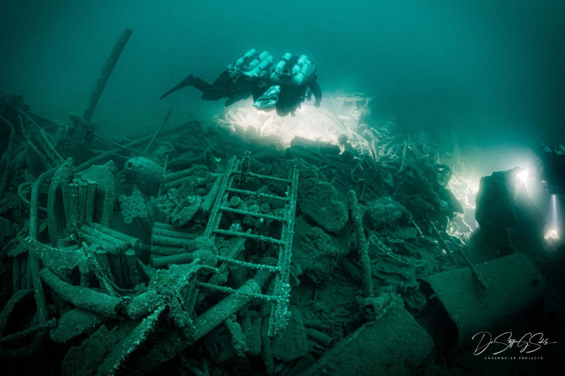 Divers swim over the wrecks of the HMS Tiger.