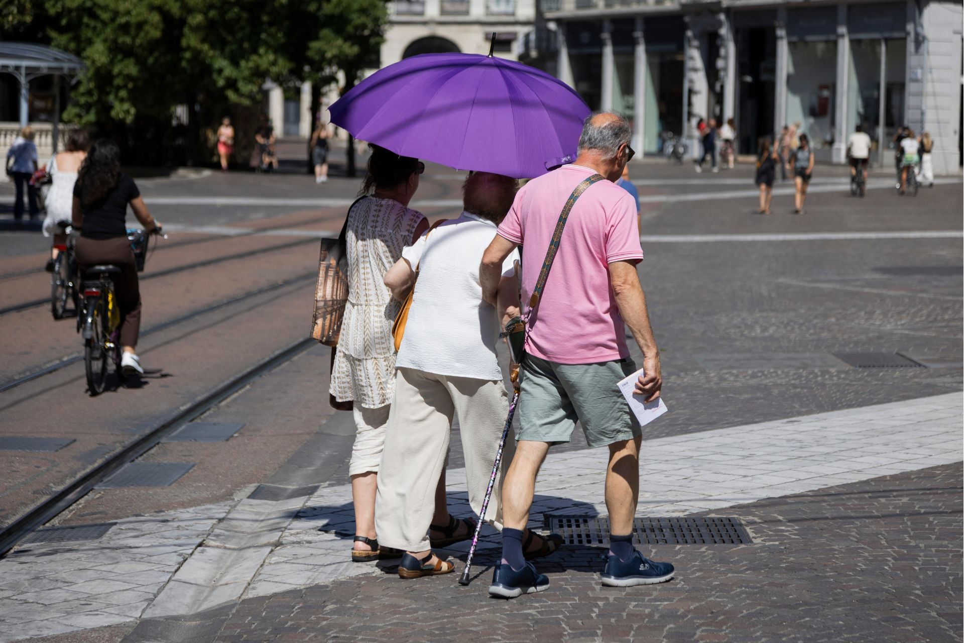 People protect themselves from the Sun during a heatwave in Grenoble, France, on July 2, 2026.