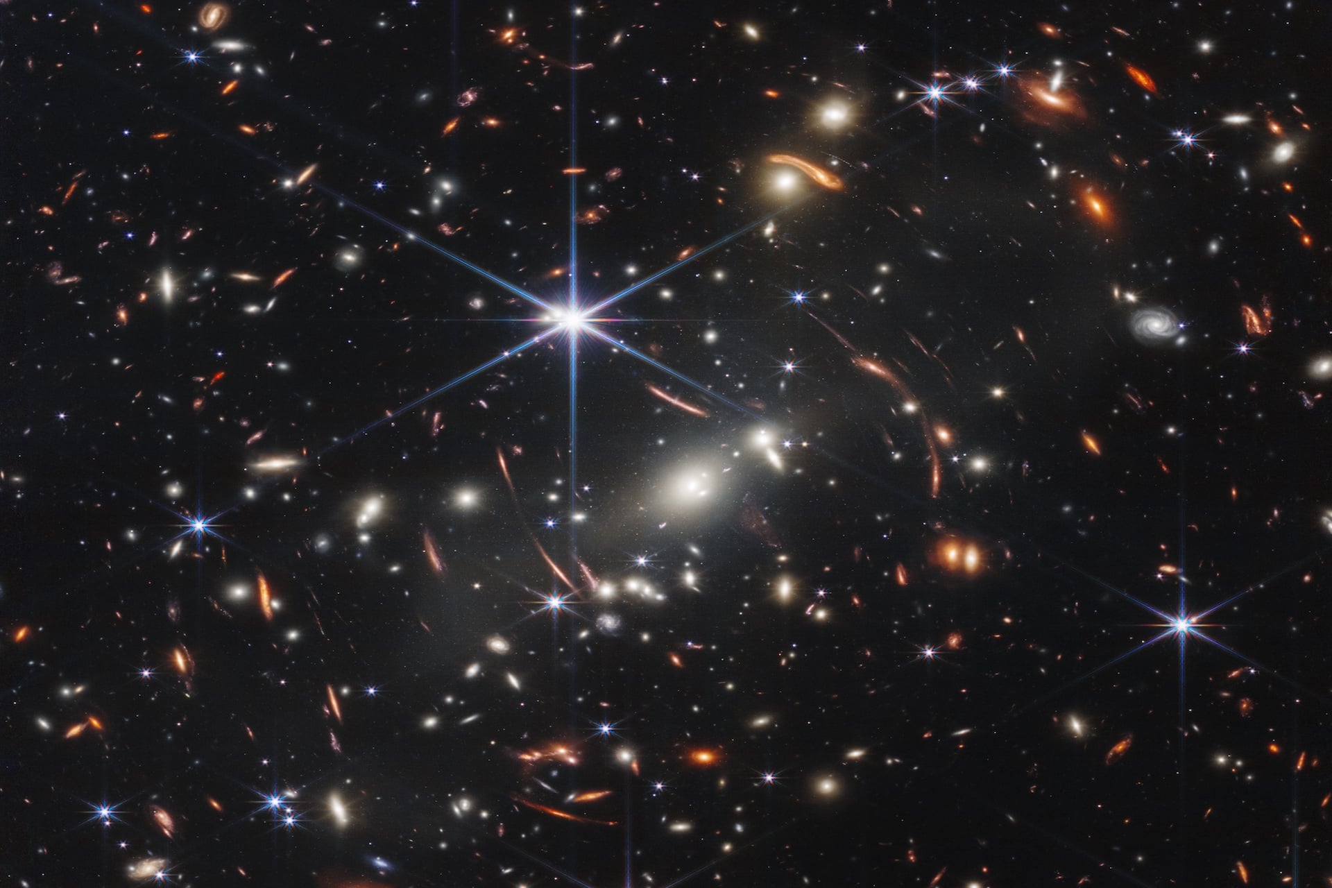 Thousands of galaxies flood this near-infrared image of galaxy cluster SMACS 0723. 