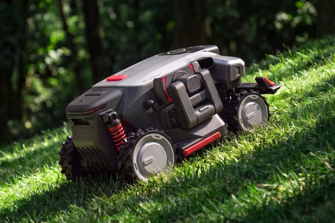 Eufy Robot Mower S2 Max driing down a grassy hill.