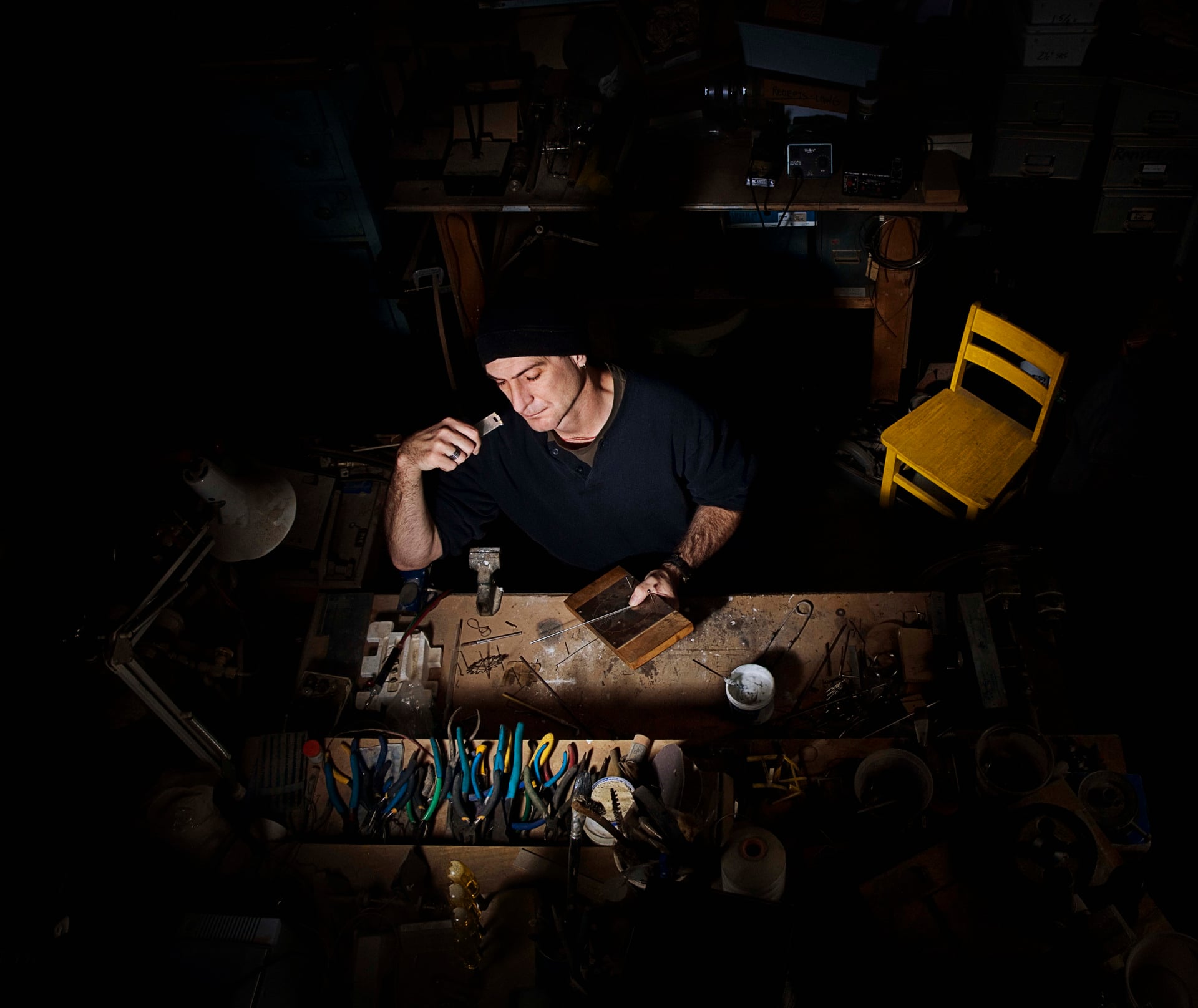 Arthur Ganson sitting at his work desk.